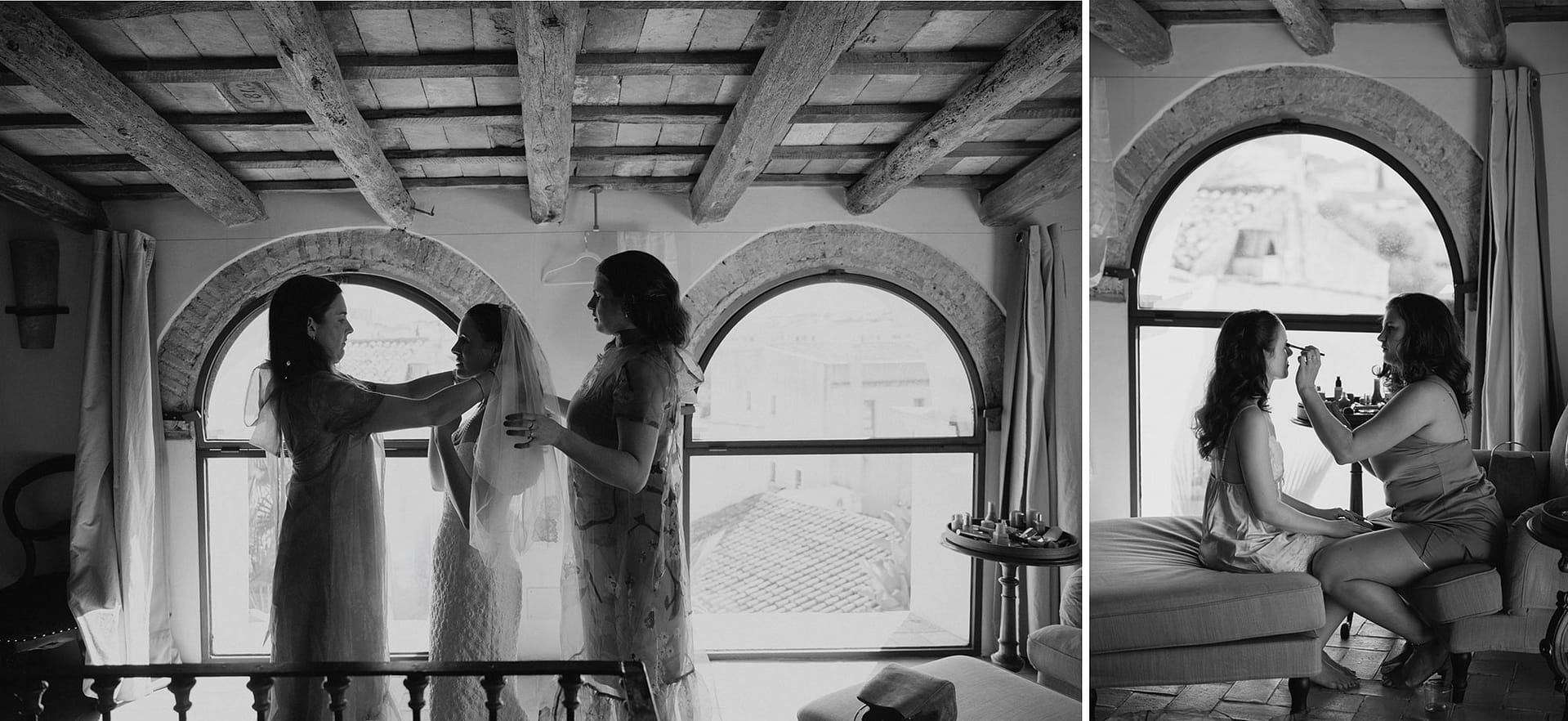 Bride getting ready with help from bridesmaids in a room with arched windows. - Barcelona Wedding Photographer