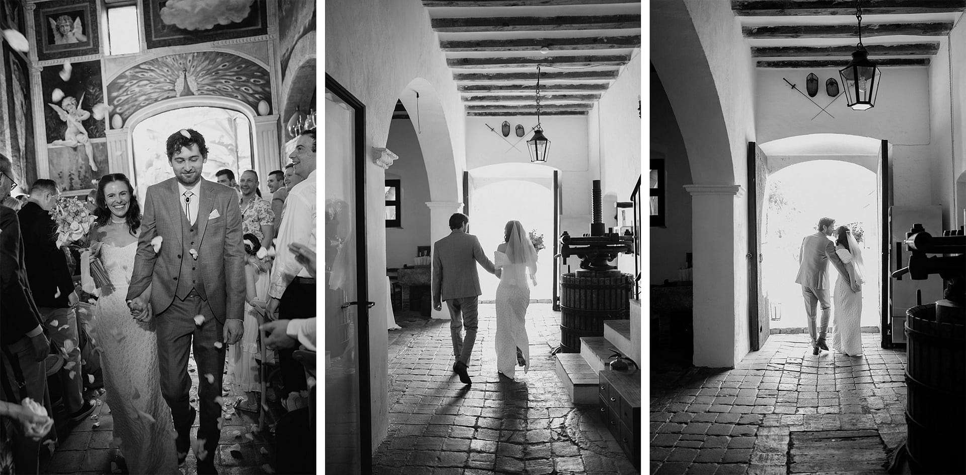 Bride and groom walking through an arched hallway, guests watch. - Barcelona Wedding Photographer