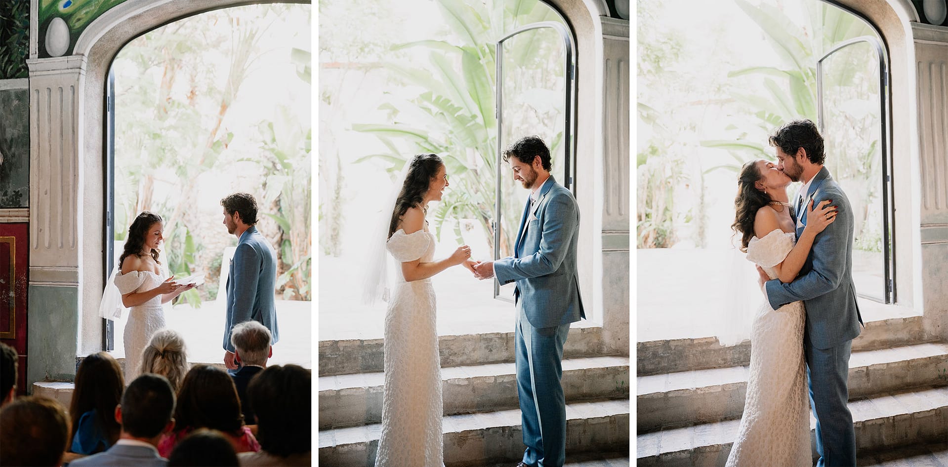 Couple exchanges vows and kisses during a wedding ceremony in an arched doorway. - Barcelona Wedding Photographer