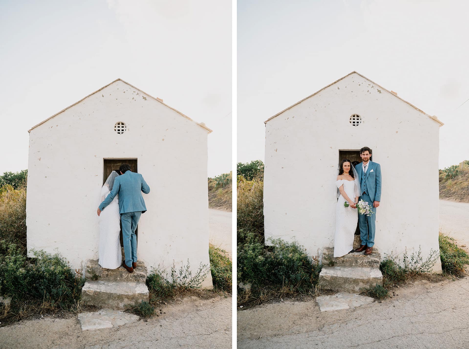 Bride and groom in blue suits pose outside a small white building on their wedding day. - Barcelona Wedding Photographer