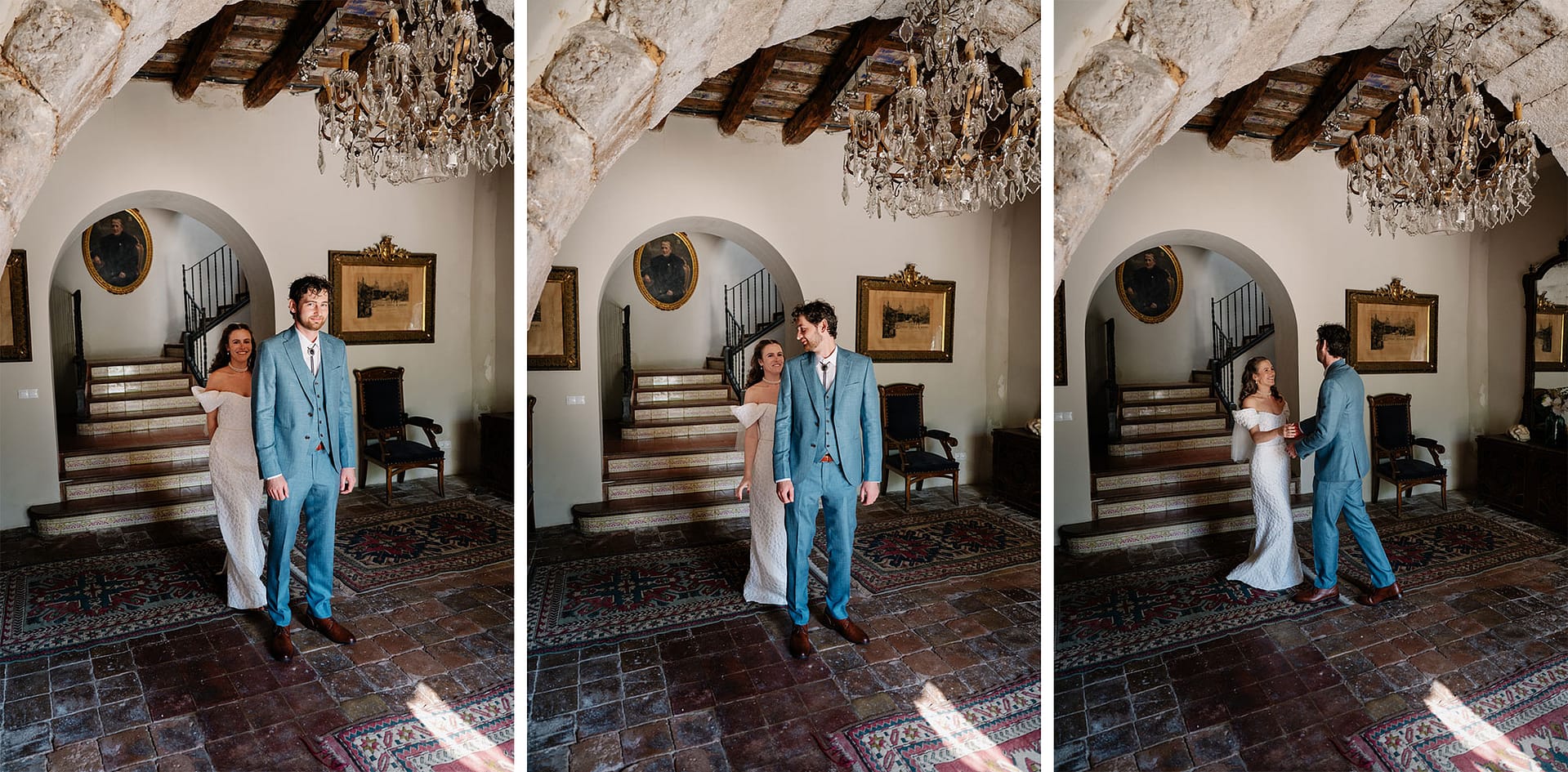 Bride and groom in elegant attire stand in a grand hall with chandeliers and ornate decor. - Barcelona Wedding Photographer