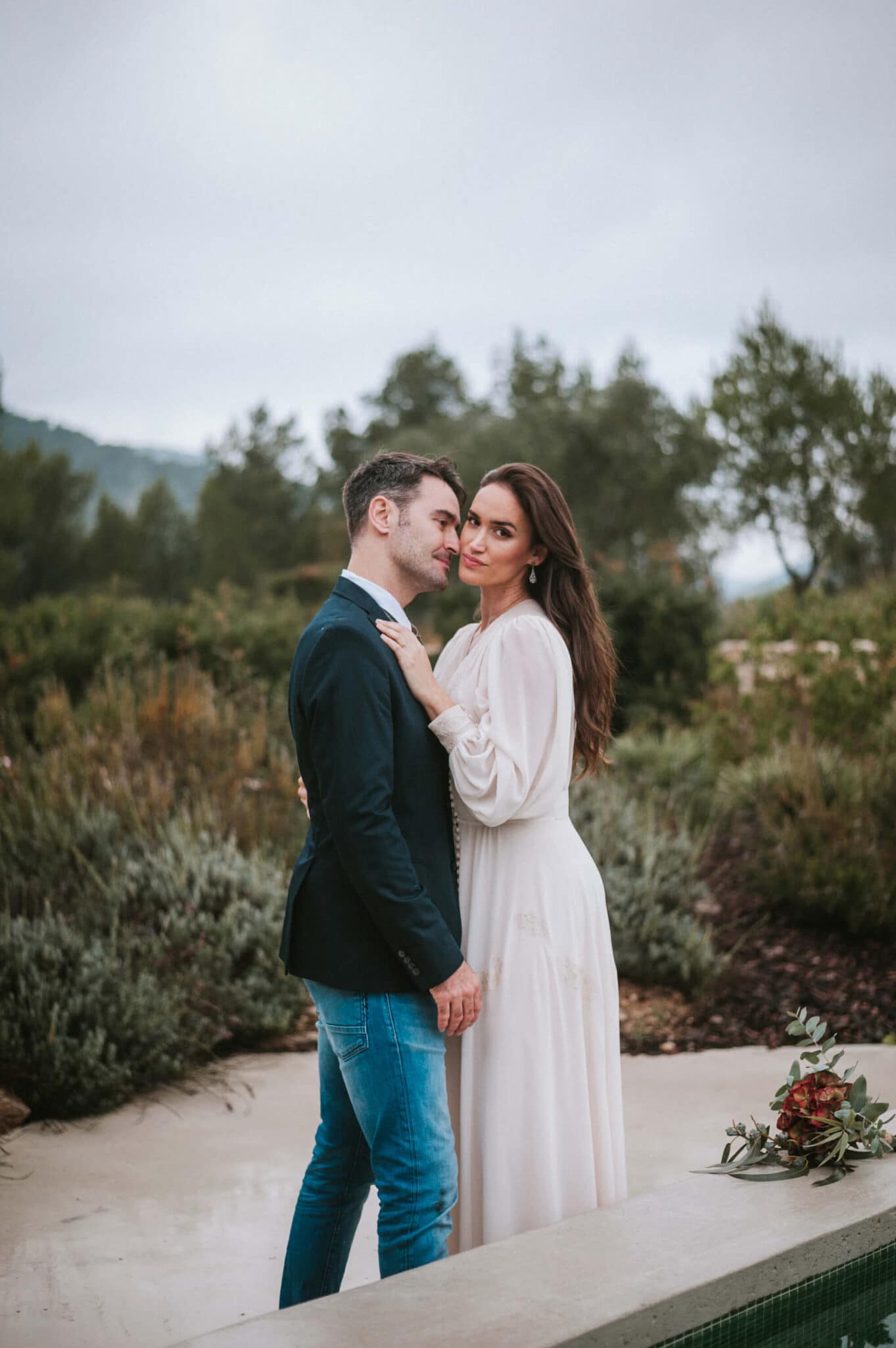 Hayley and Mark, a bride and groom, walk hand-in-hand at their wedding. - Barcelona Wedding Photographer
