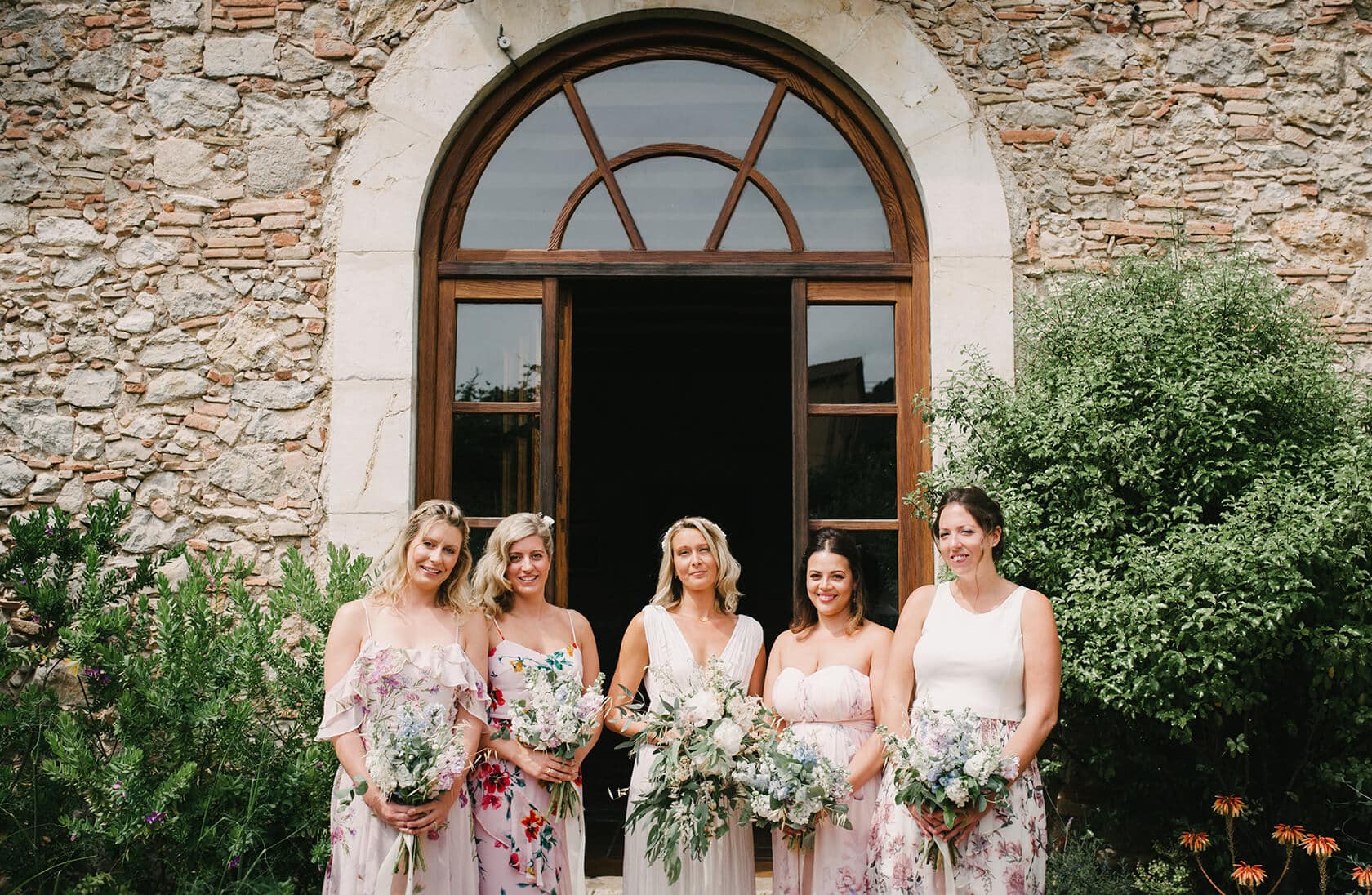Hayley and Mark, a bride and groom, walk hand-in-hand at their wedding. - Barcelona Wedding Photographer