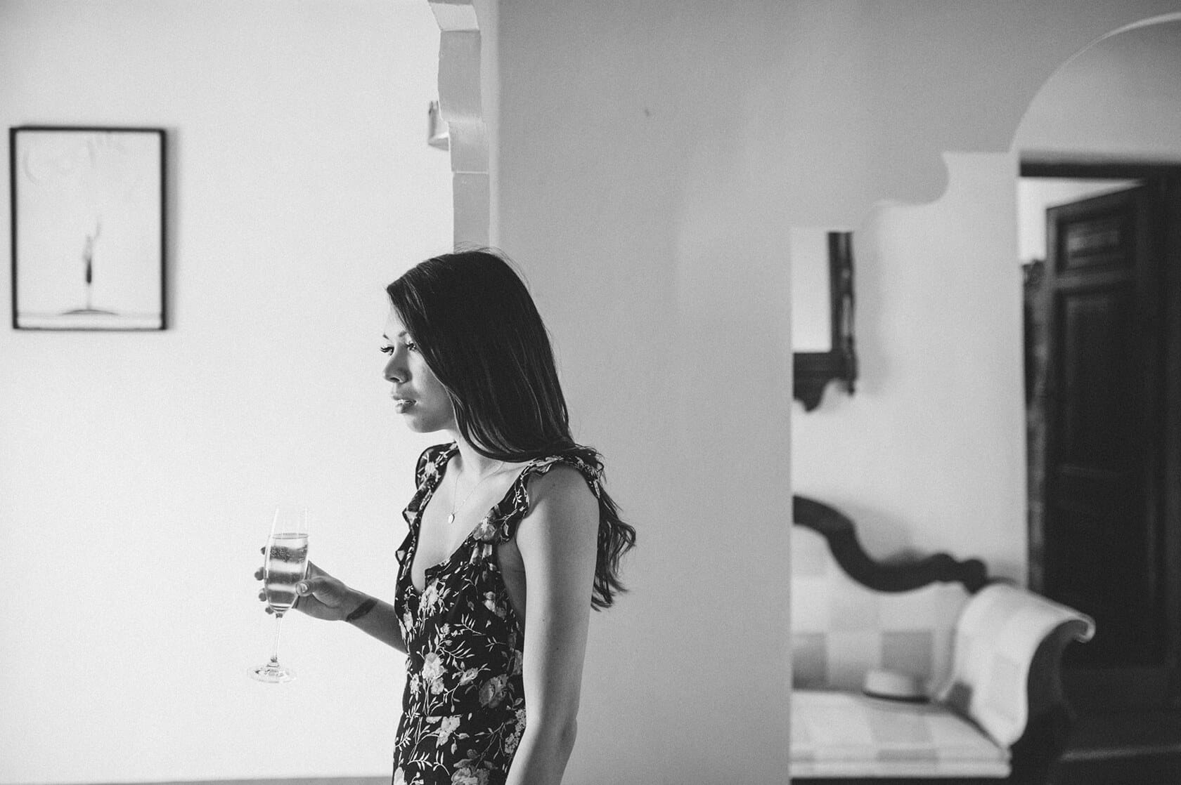 Bride Clara sips champagne in a villa at her destination wedding in Sitges - Barcelona Wedding Photographer