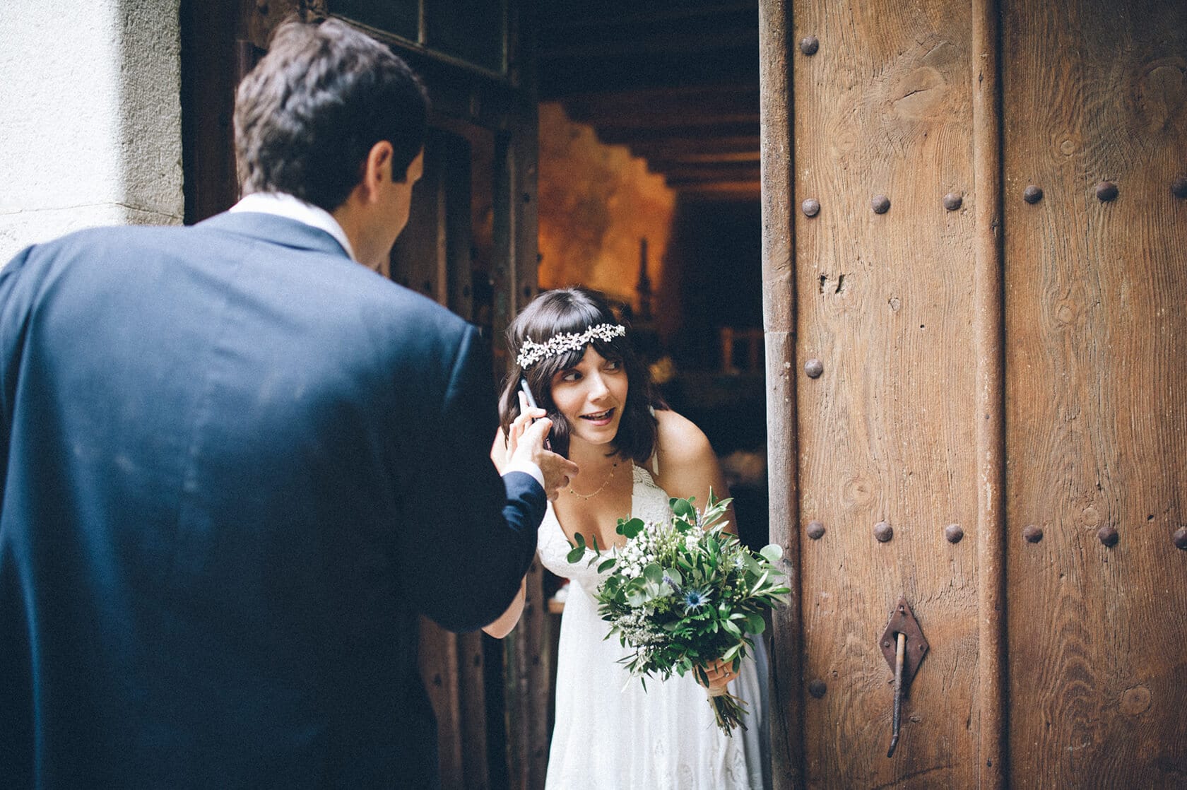 Bride with bouquet on phone at Villa Almanita, Sitges destination wedding - Barcelona Wedding Photographer