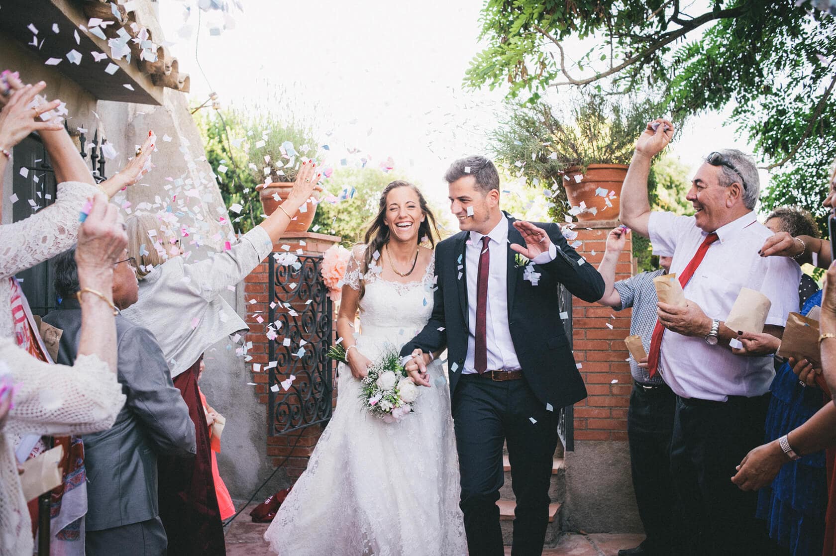 Cris & Rafa's wedding in Barcelona, confetti shower as couple exits. - Barcelona Wedding Photographer