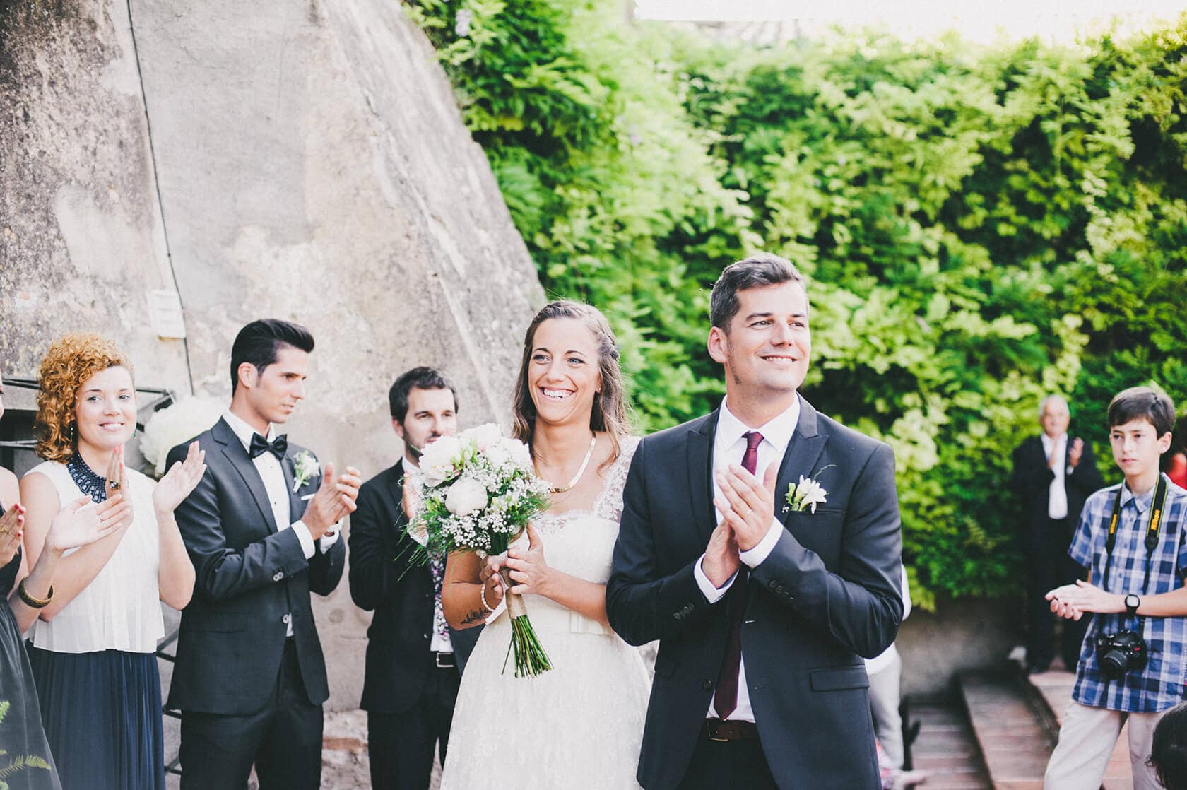 Bride and groom clap hands at outdoor wedding ceremony in Barcelona - Barcelona Wedding Photographer