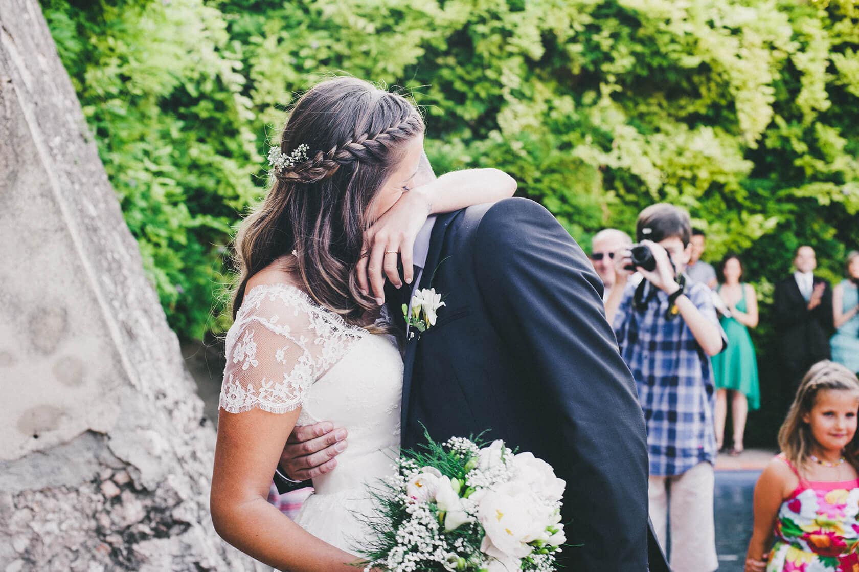 Cris & Rafa wedding: Bride and groom embrace, guests watch, Barcelona wedding photographer - Barcelona Wedding Photographer