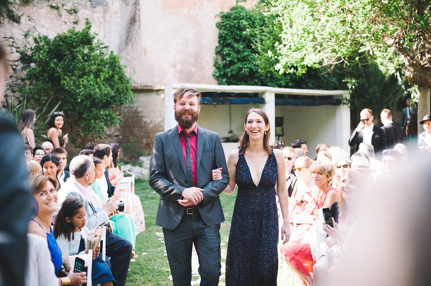 Couple walking down aisle at Villa Almanita, Sitges destination wedding. - Barcelona Wedding Photographer