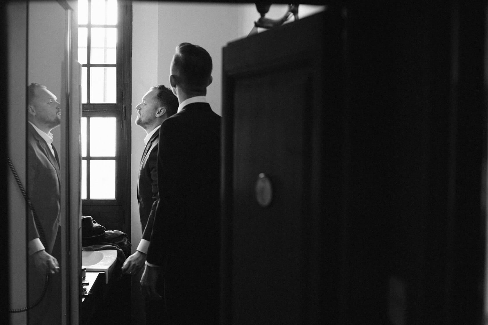 Groom in suit reflected in mirror at Villa Almanita, Sitges destination wedding - Barcelona Wedding Photographer