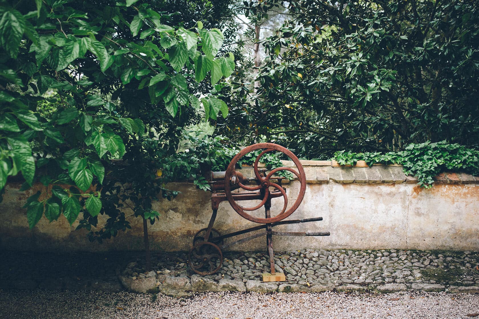 Rustic antique machine in a garden at Villa Almanita, Sitges - Barcelona Wedding Photographer