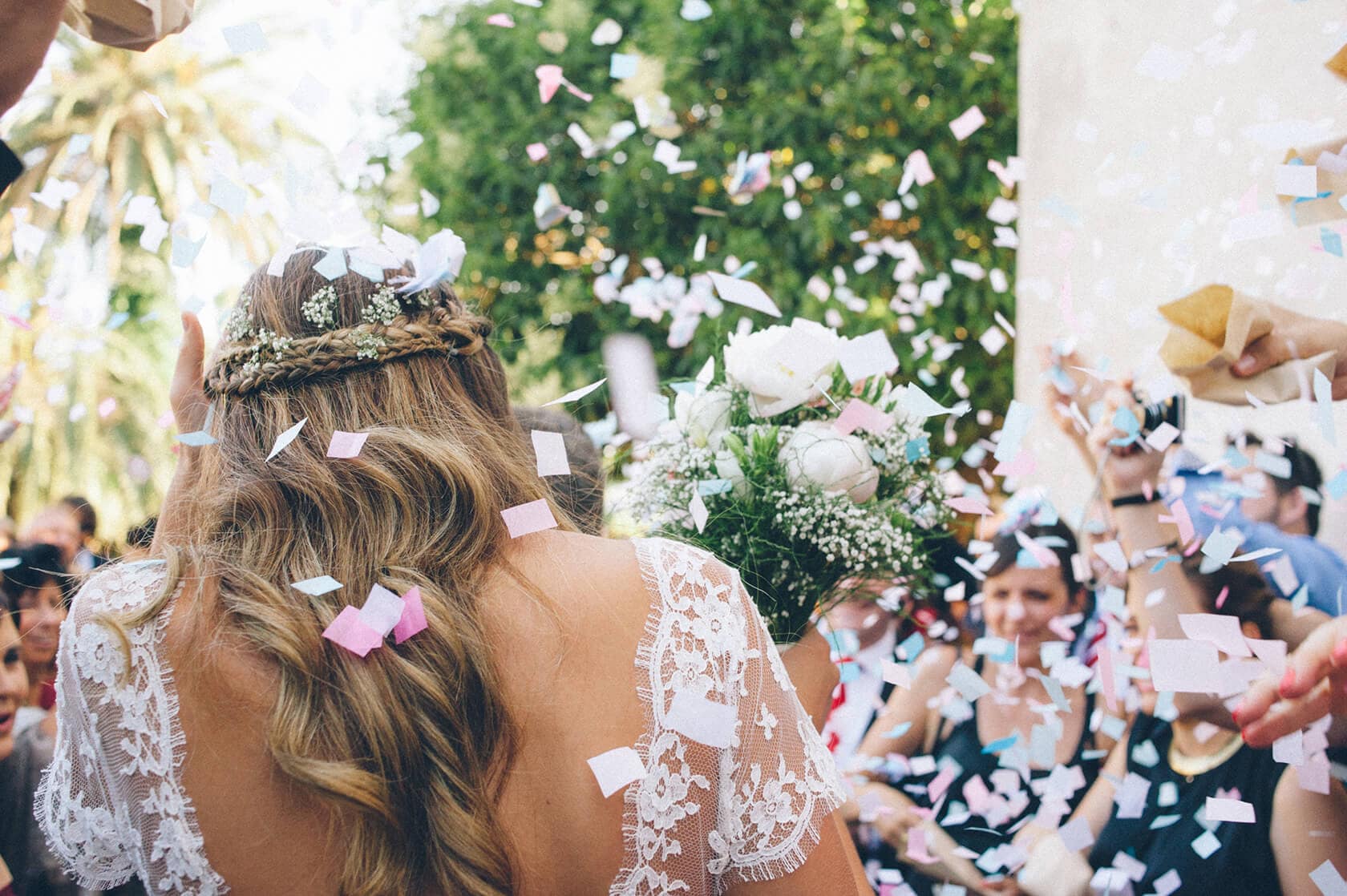 Bride and groom showered with confetti at a Barcelona wedding. - Barcelona Wedding Photographer