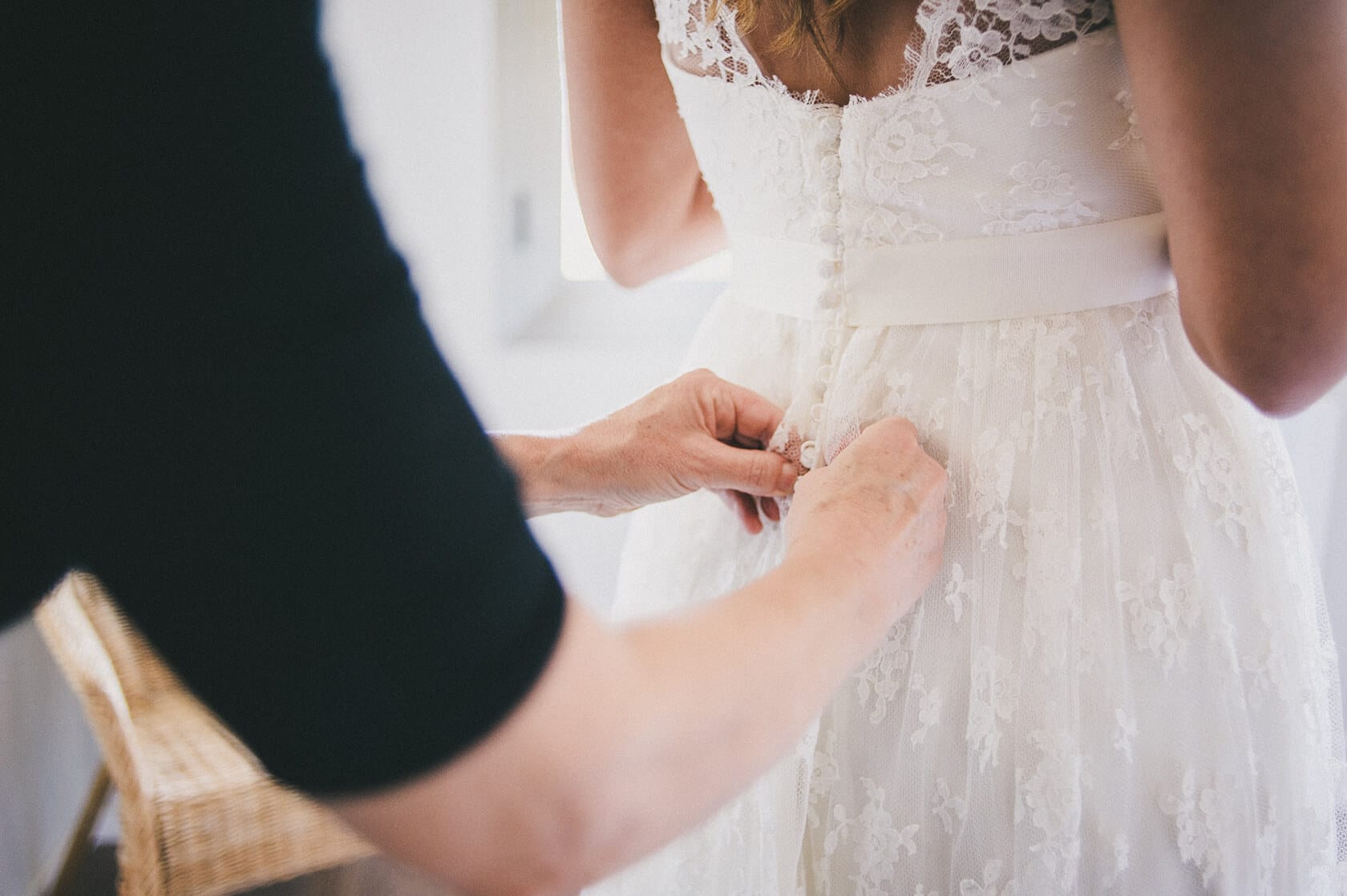 Bride's wedding dress being buttoned up, Barcelona wedding photographer - Barcelona Wedding Photographer
