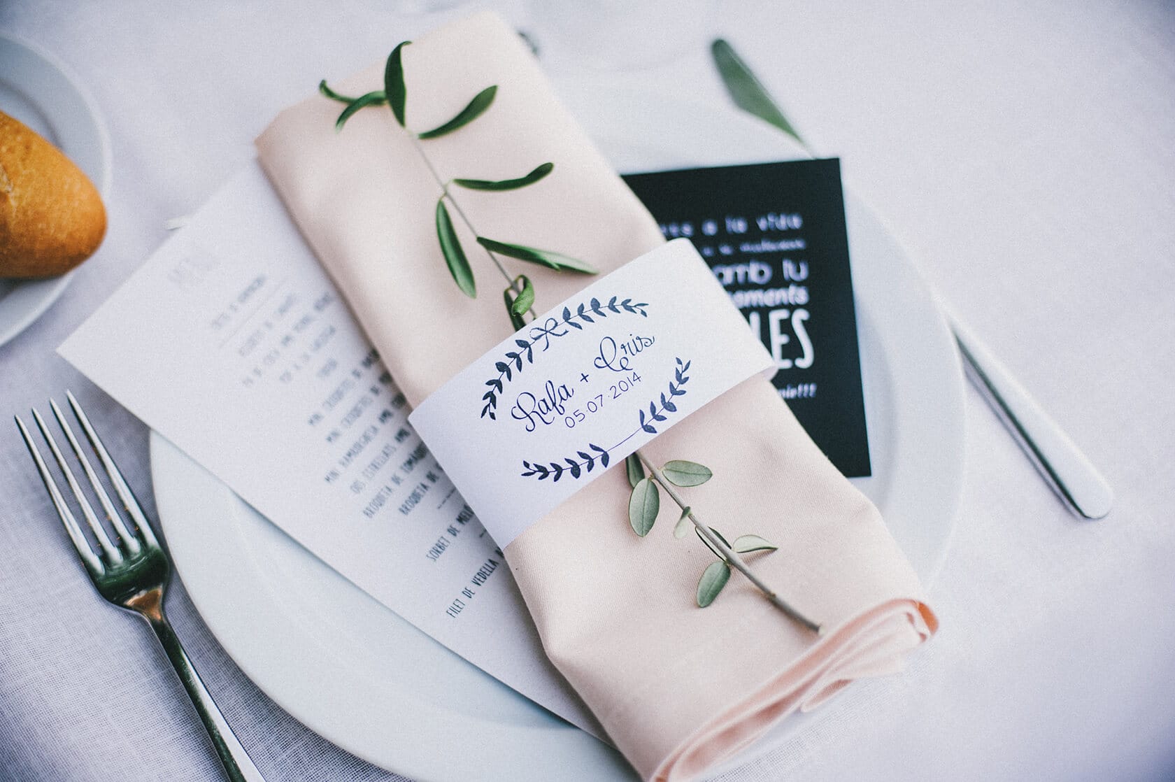 Wedding place setting with menu, napkin, and olive branch, Barcelona - Barcelona Wedding Photographer