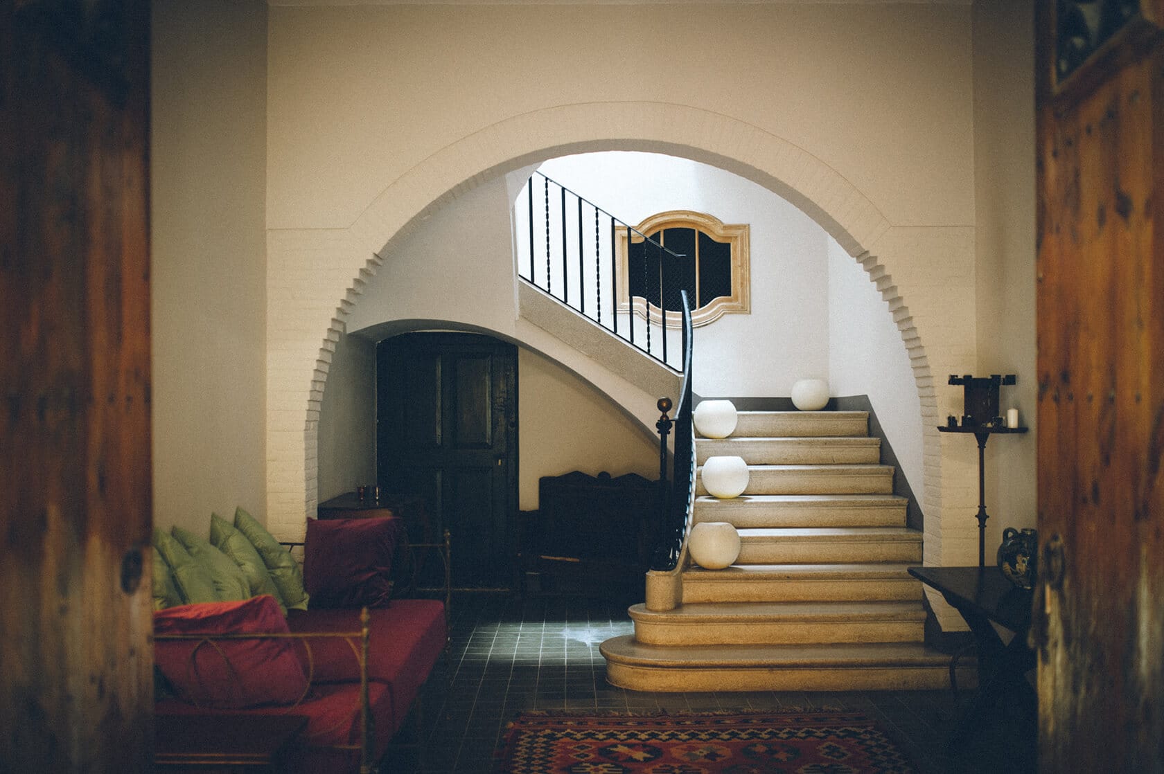 Elegant staircase with arched entryway in a Barcelona wedding venue. - Barcelona Wedding Photographer