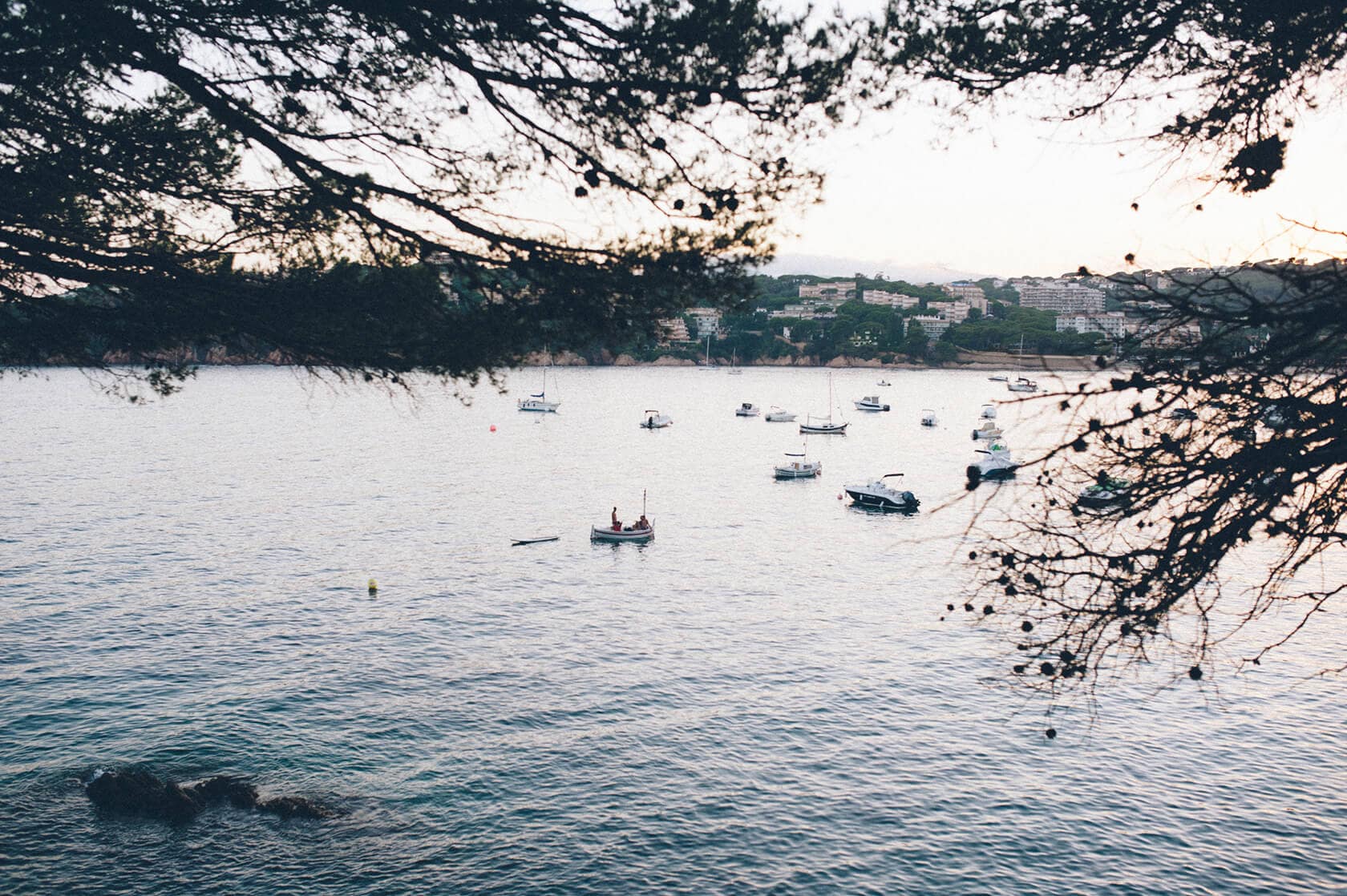 Boats anchored in a bay near a coastal town in S'Agaro, Spain. - Barcelona Wedding Photographer