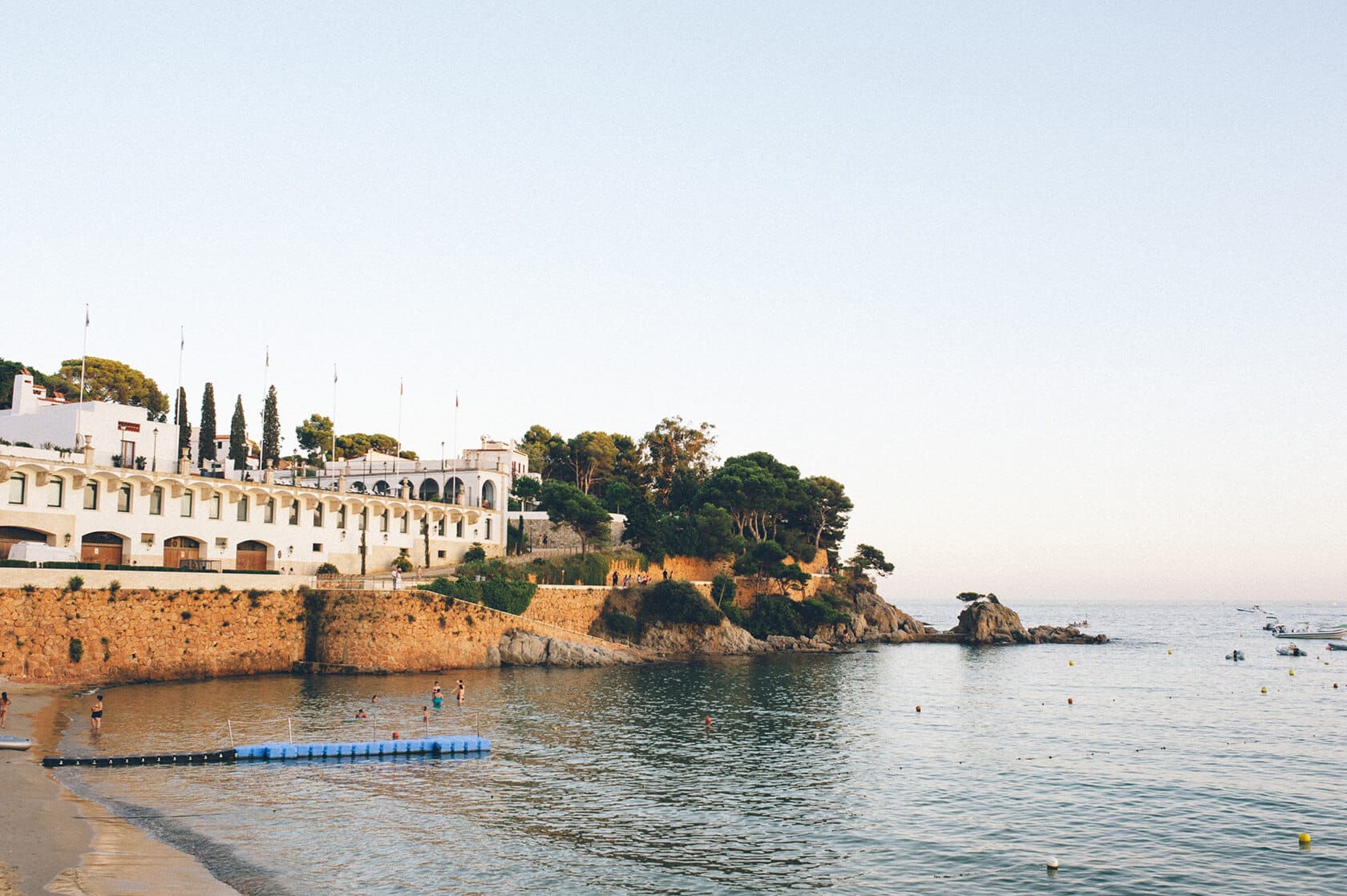Wedding photographer captures S'Agaro Spain coastal resort with people swimming - Barcelona Wedding Photographer