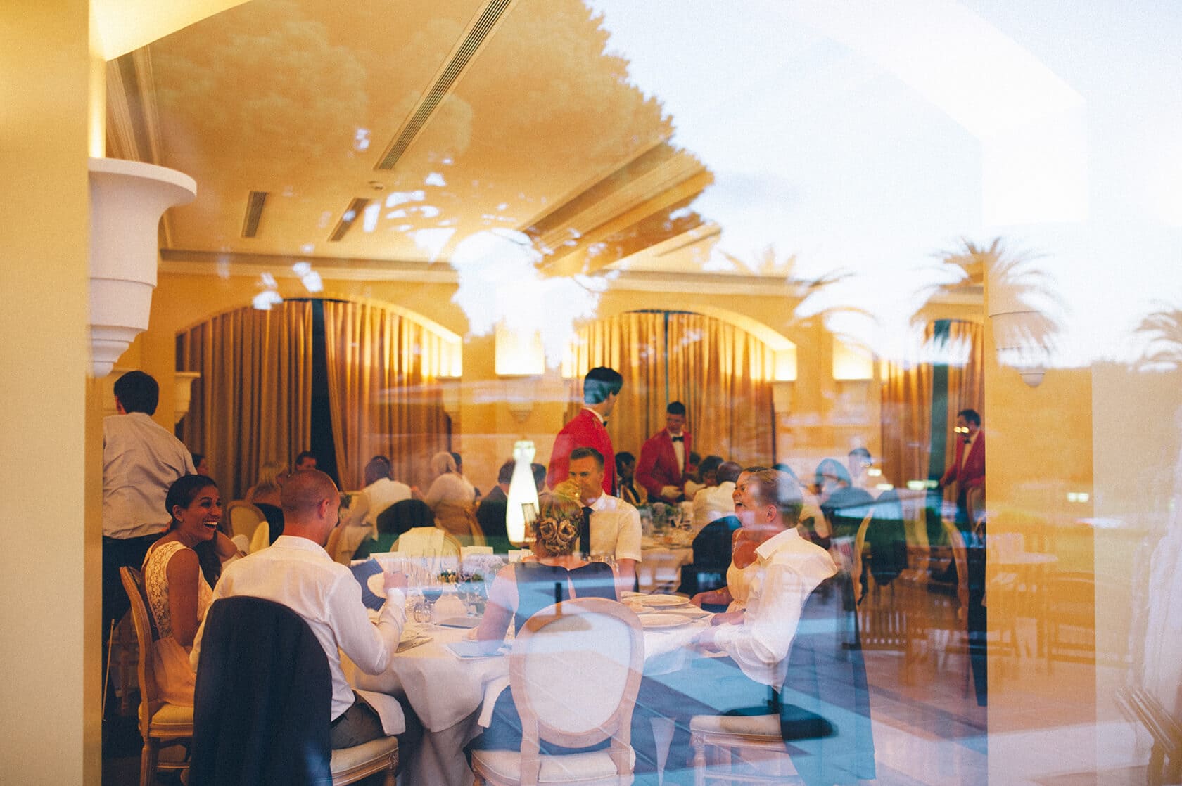Wedding guests dining at reception in S'Agaro, Spain. - Barcelona Wedding Photographer