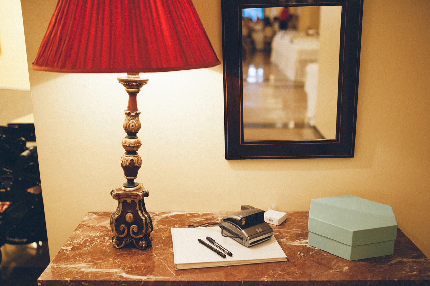 Table with lamp, pens, and gift box, wedding photographer S'Agaro Spain - Barcelona Wedding Photographer