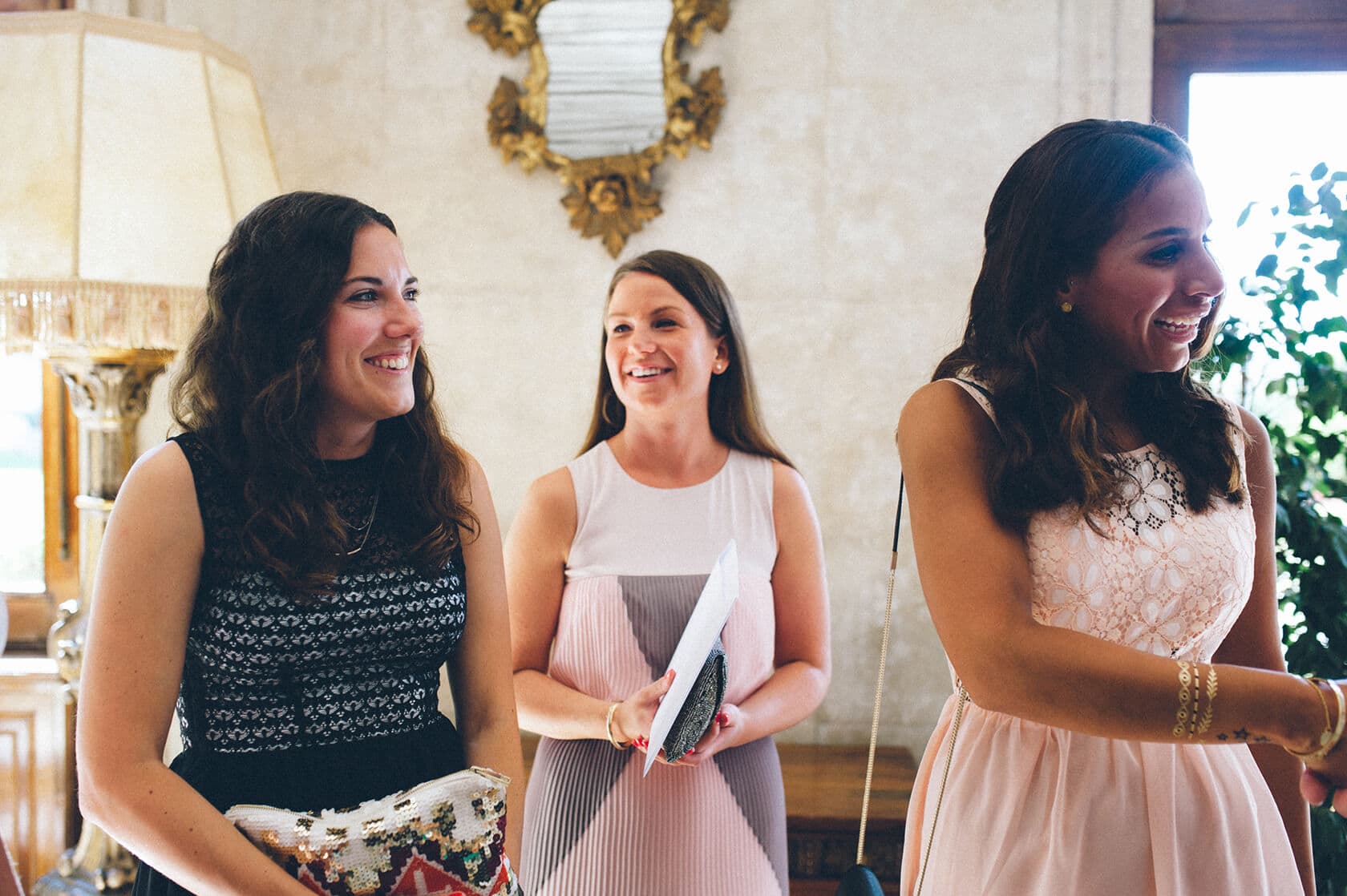 Tsega & Anders wedding photographer: Three women smiling at a Spanish wedding - Barcelona Wedding Photographer