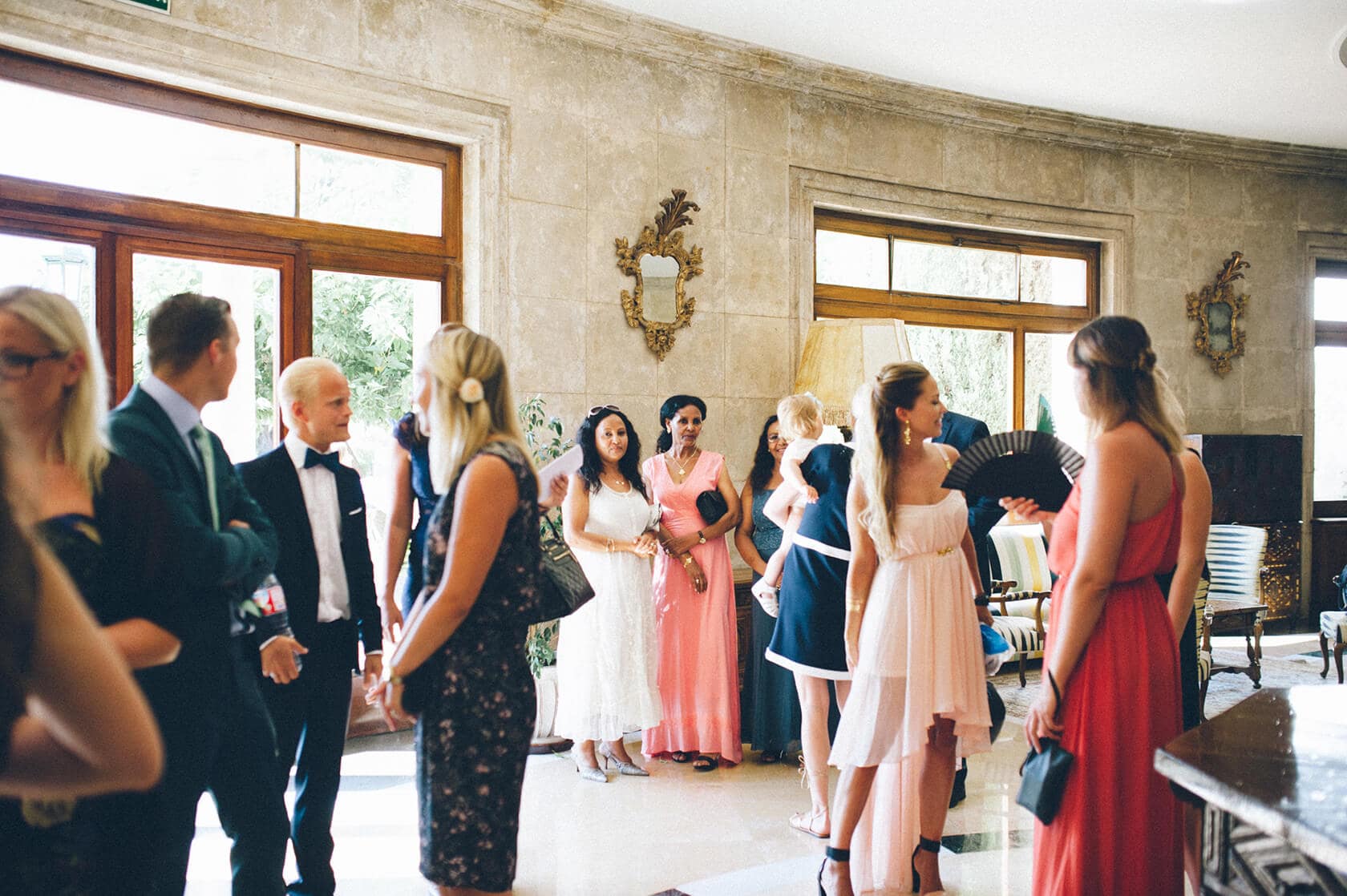 Wedding guests in formal attire at Tsega & Anders' S'Agaro wedding in Spain. - Barcelona Wedding Photographer