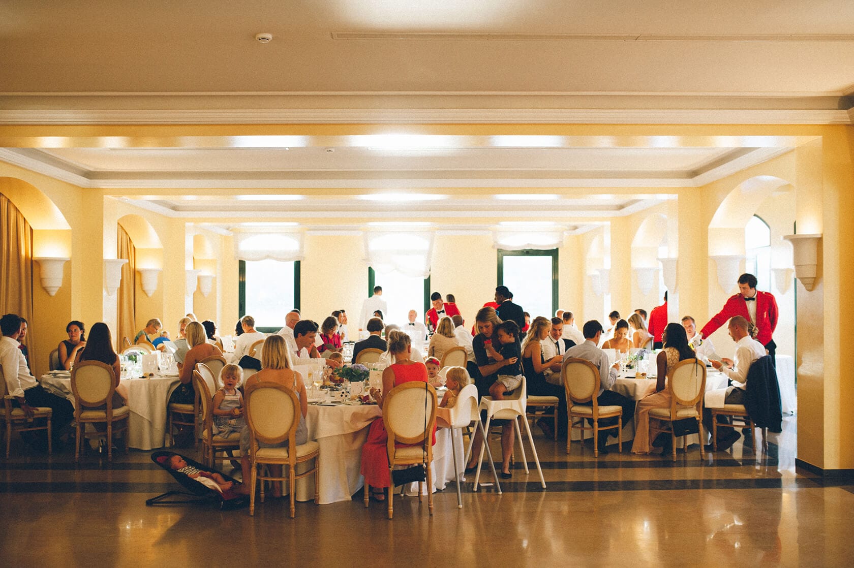 Wedding reception in a hall with guests seated at tables, Tsega & Anders - Barcelona Wedding Photographer