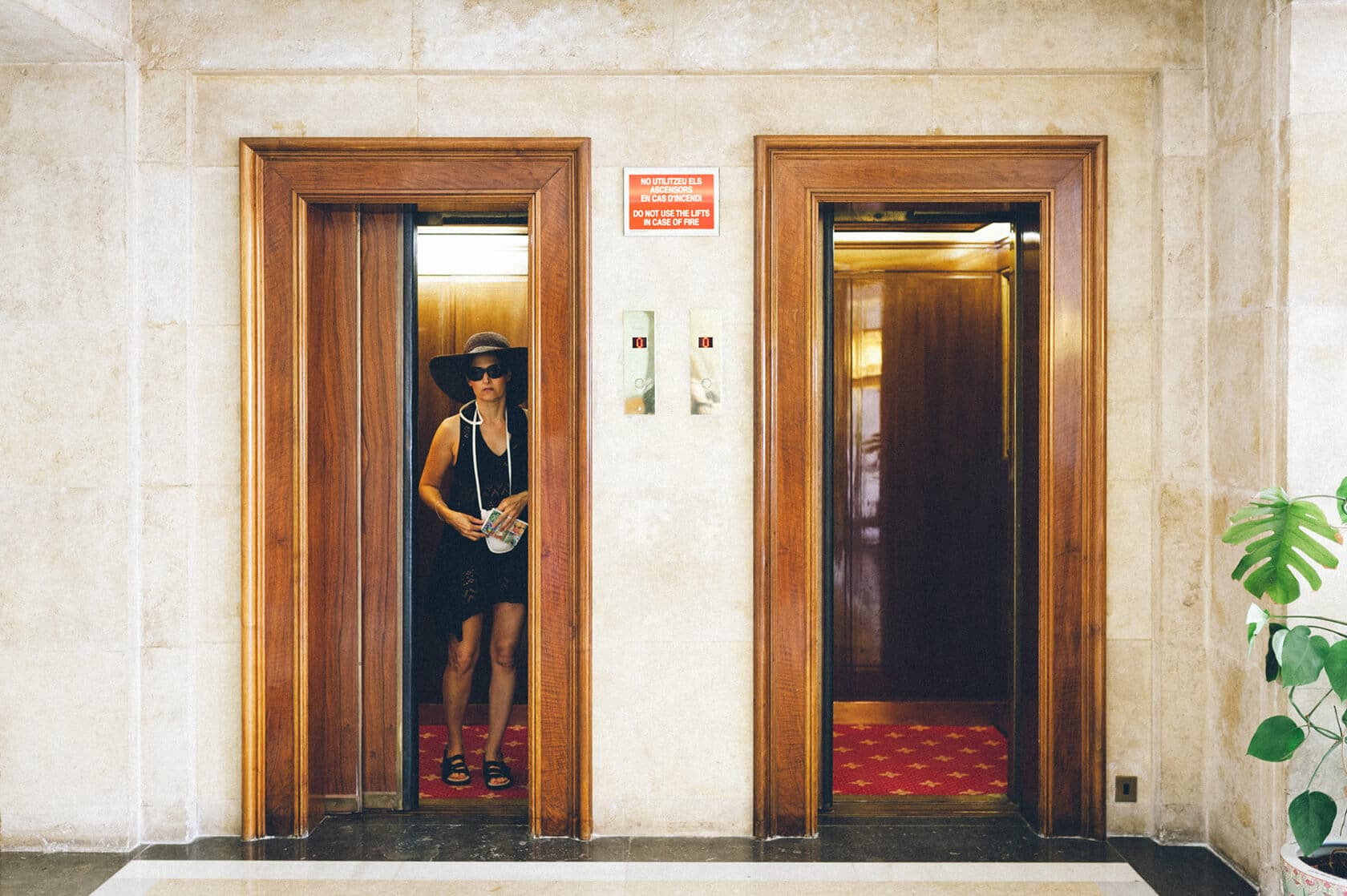Tsega & Anders wedding photographer in S'Agaro, Spain: woman in elevator - Barcelona Wedding Photographer