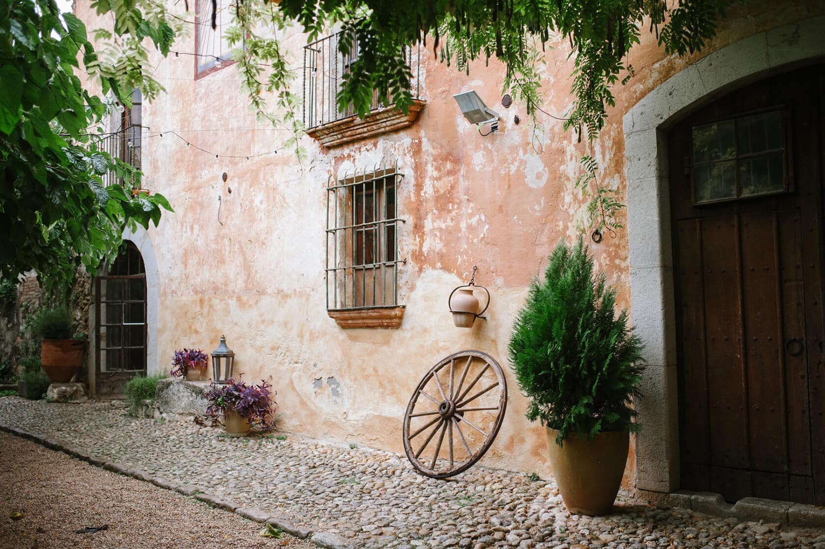 Charming stone courtyard of a wedding villa in Sitges with rustic decor. - Barcelona Wedding Photographer