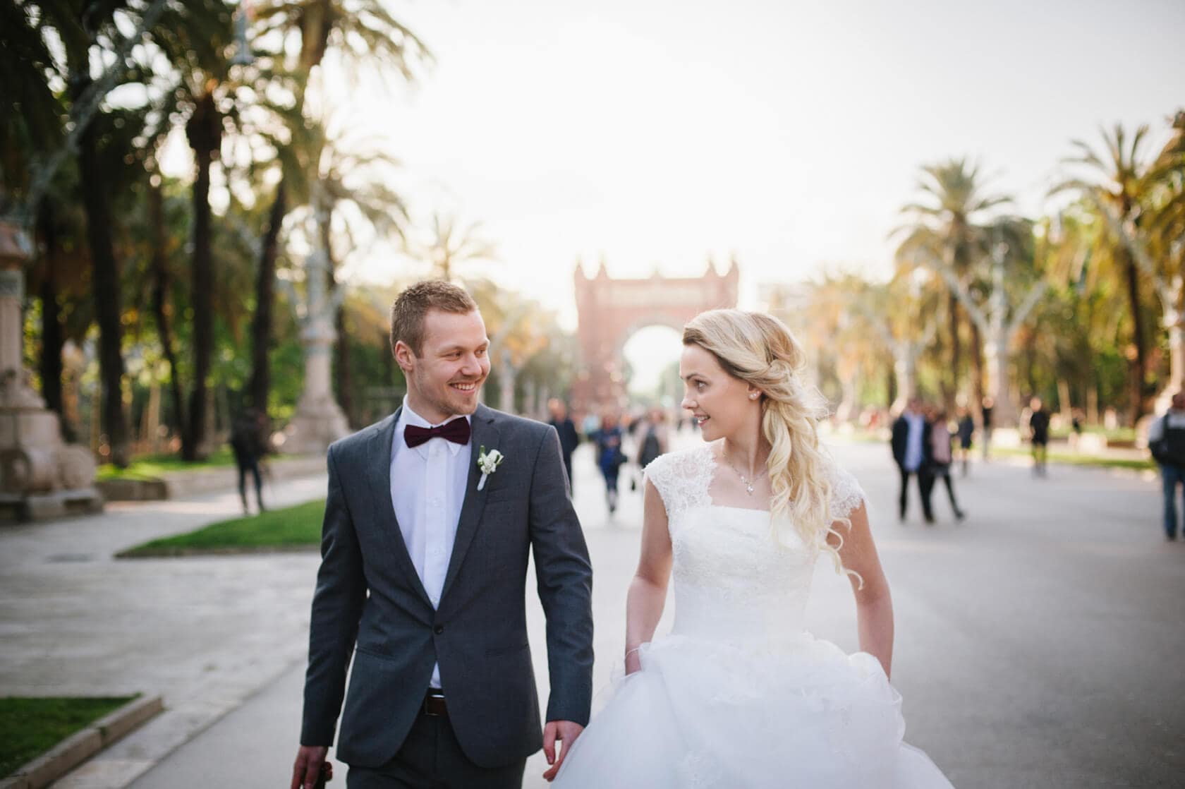 Bride and groom walking in Barcelona, Spain, with a Barcelona wedding photographer. - Barcelona Wedding Photographer