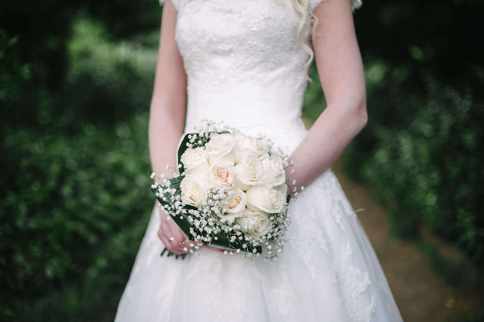Bride in white wedding dress holding a bouquet of white roses, Barcelona wedding photographer - Barcelona Wedding Photographer