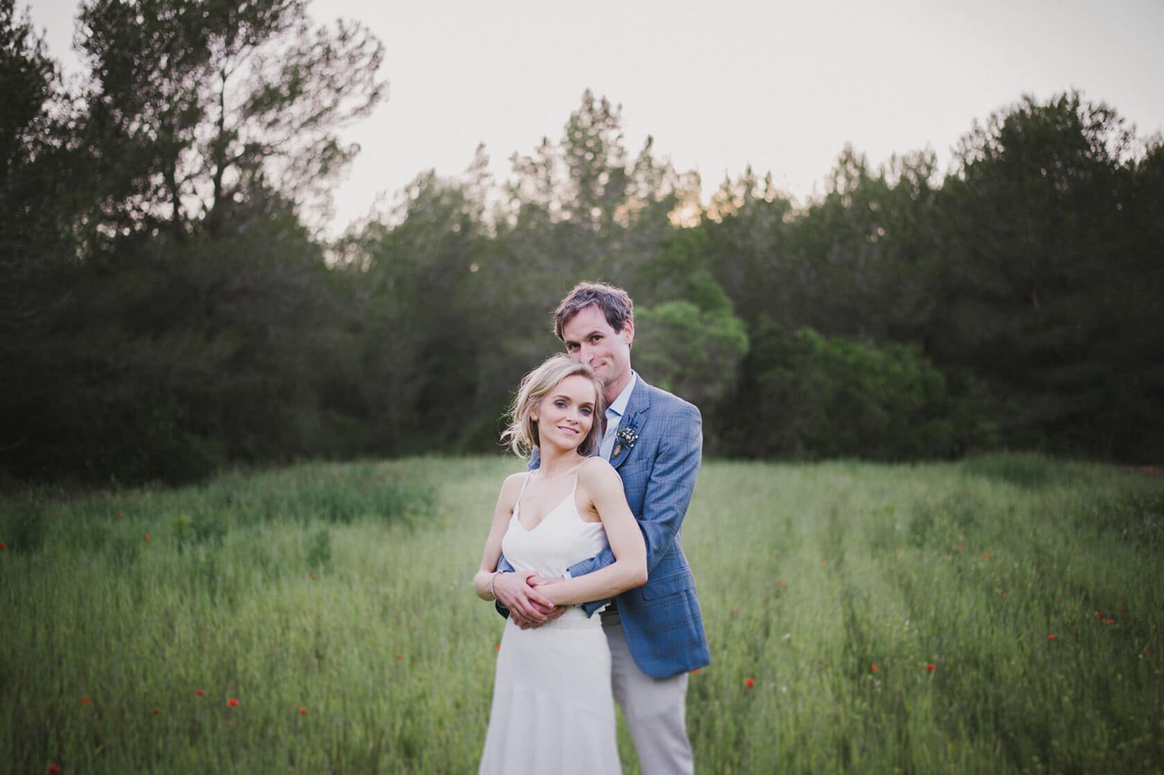 Bride and groom embrace in a field at Casanova Estate wedding venue - Barcelona Wedding Photographer