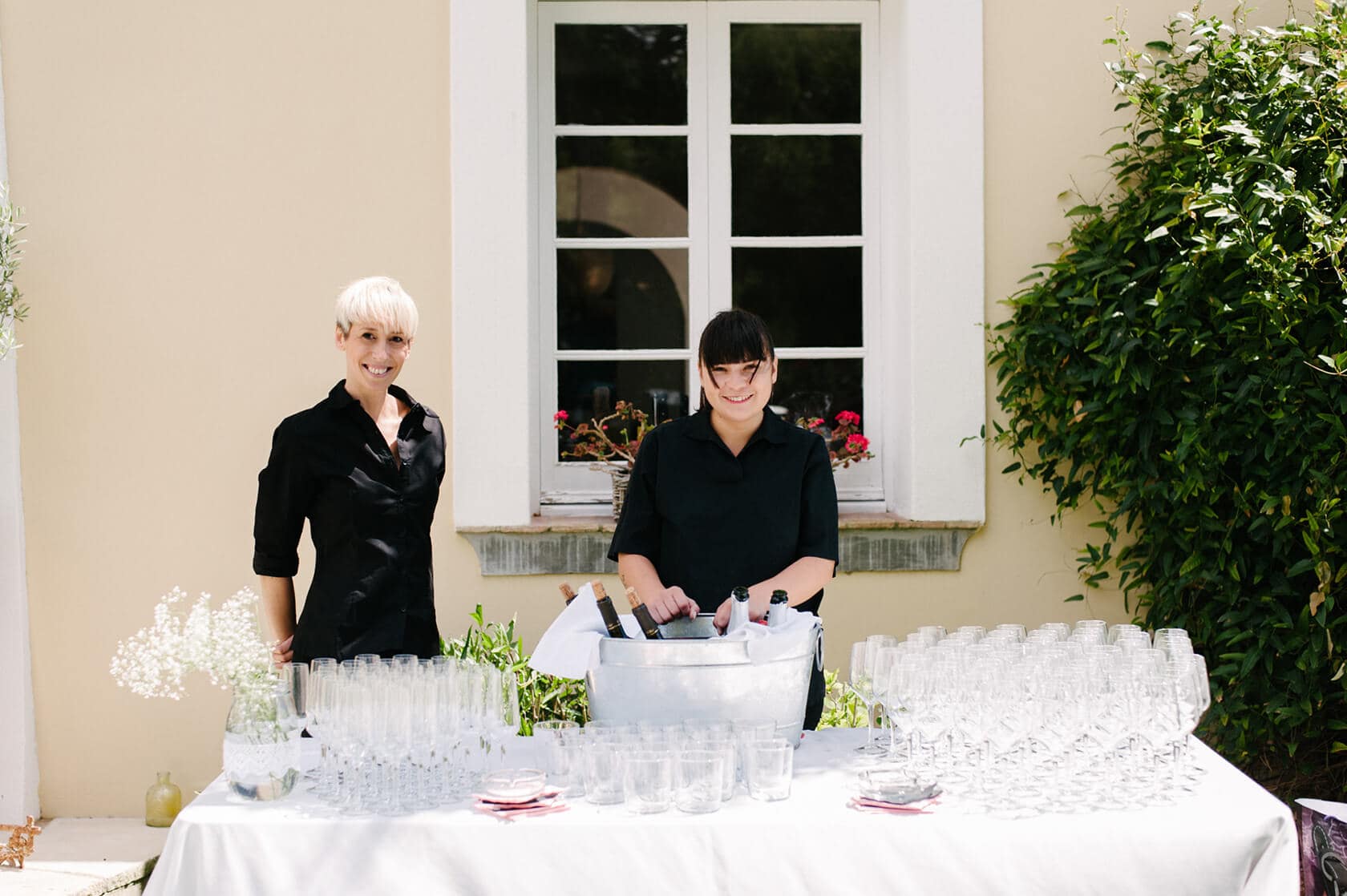 Two servers at a Casanova Estate wedding venue bar with champagne glasses - Barcelona Wedding Photographer