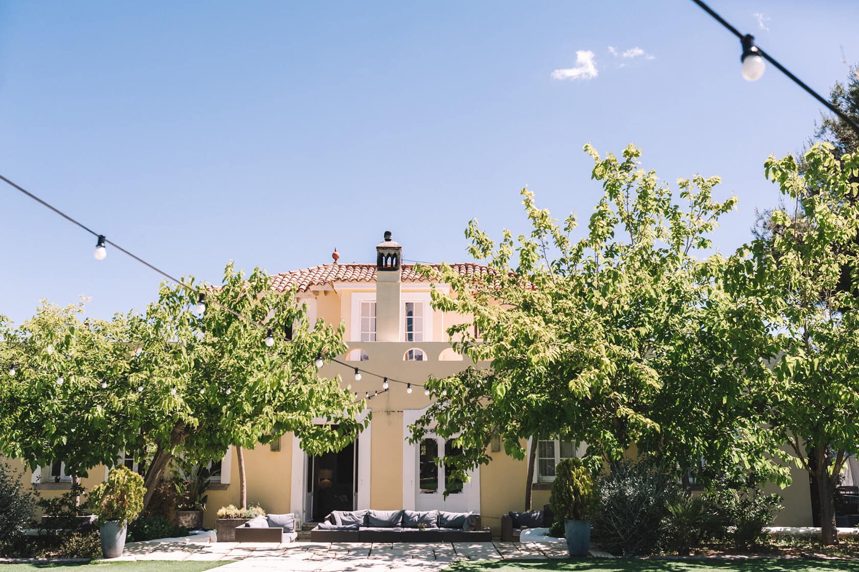 Casanova Estate wedding venue: Yellow house with trees and outdoor seating - Barcelona Wedding Photographer
