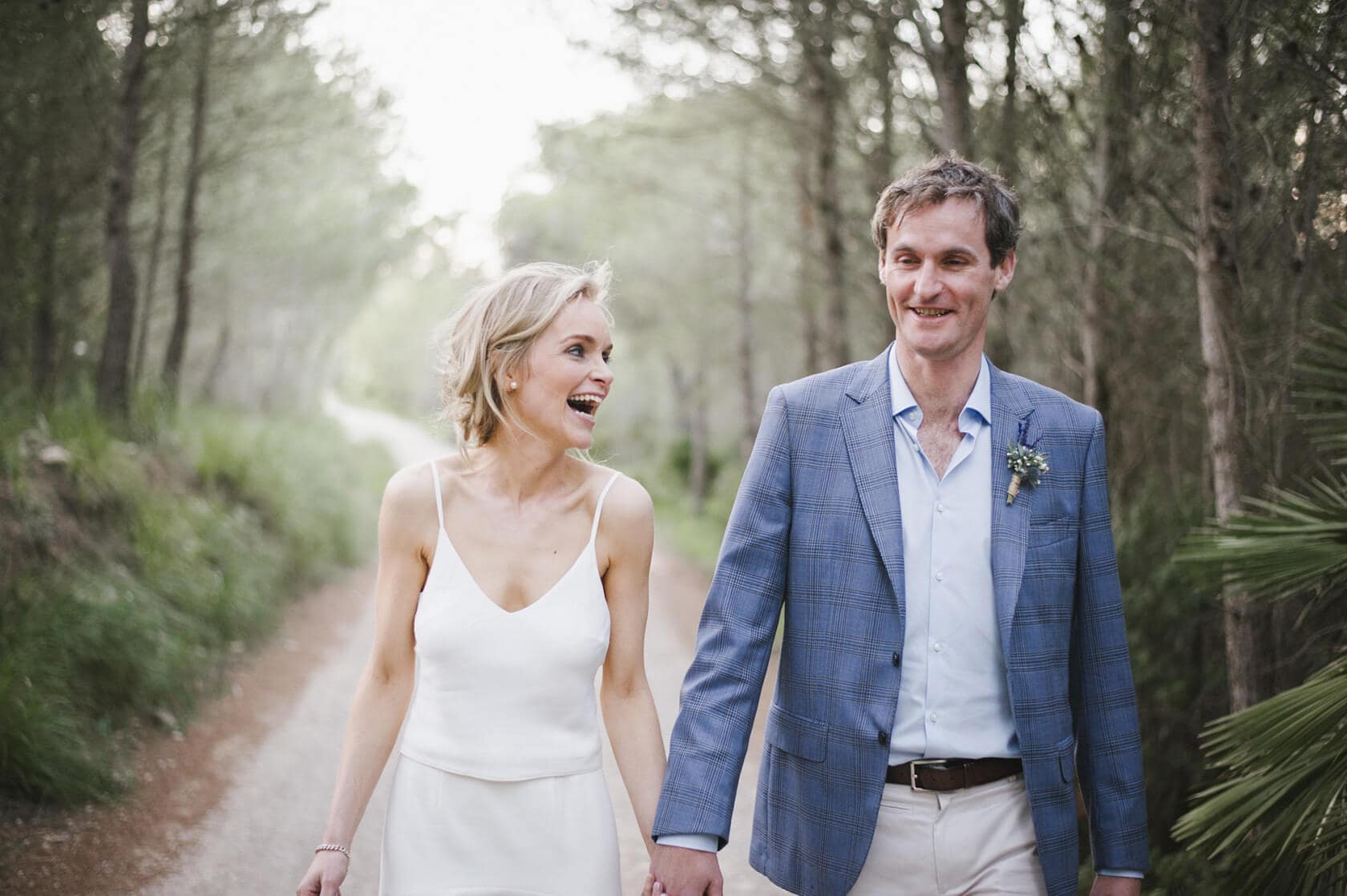 Catherine and James walking hand-in-hand at their Casanova Estate wedding venue. - Barcelona Wedding Photographer