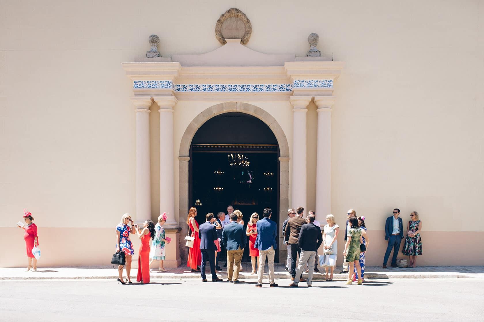 Guests in formal attire gather at the entrance of Casanova Estate for a wedding. - Barcelona Wedding Photographer