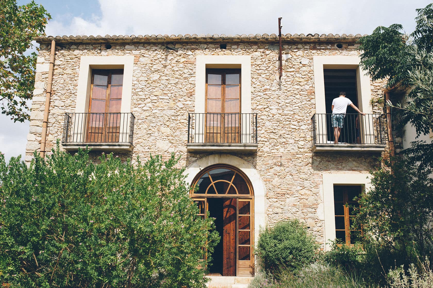 Man on balcony of stone wedding villa in Sitges - Barcelona Wedding Photographer
