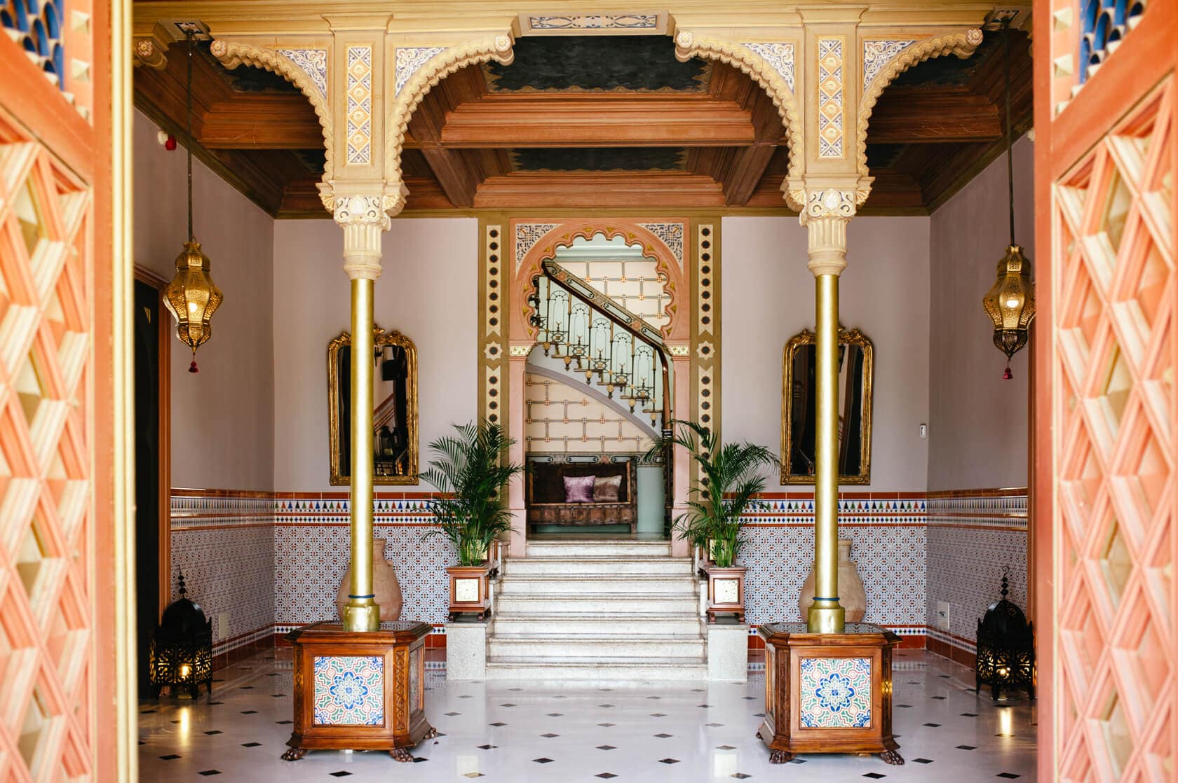 Elegant entrance hall of a wedding villa in Sitges with a grand staircase. - Barcelona Wedding Photographer