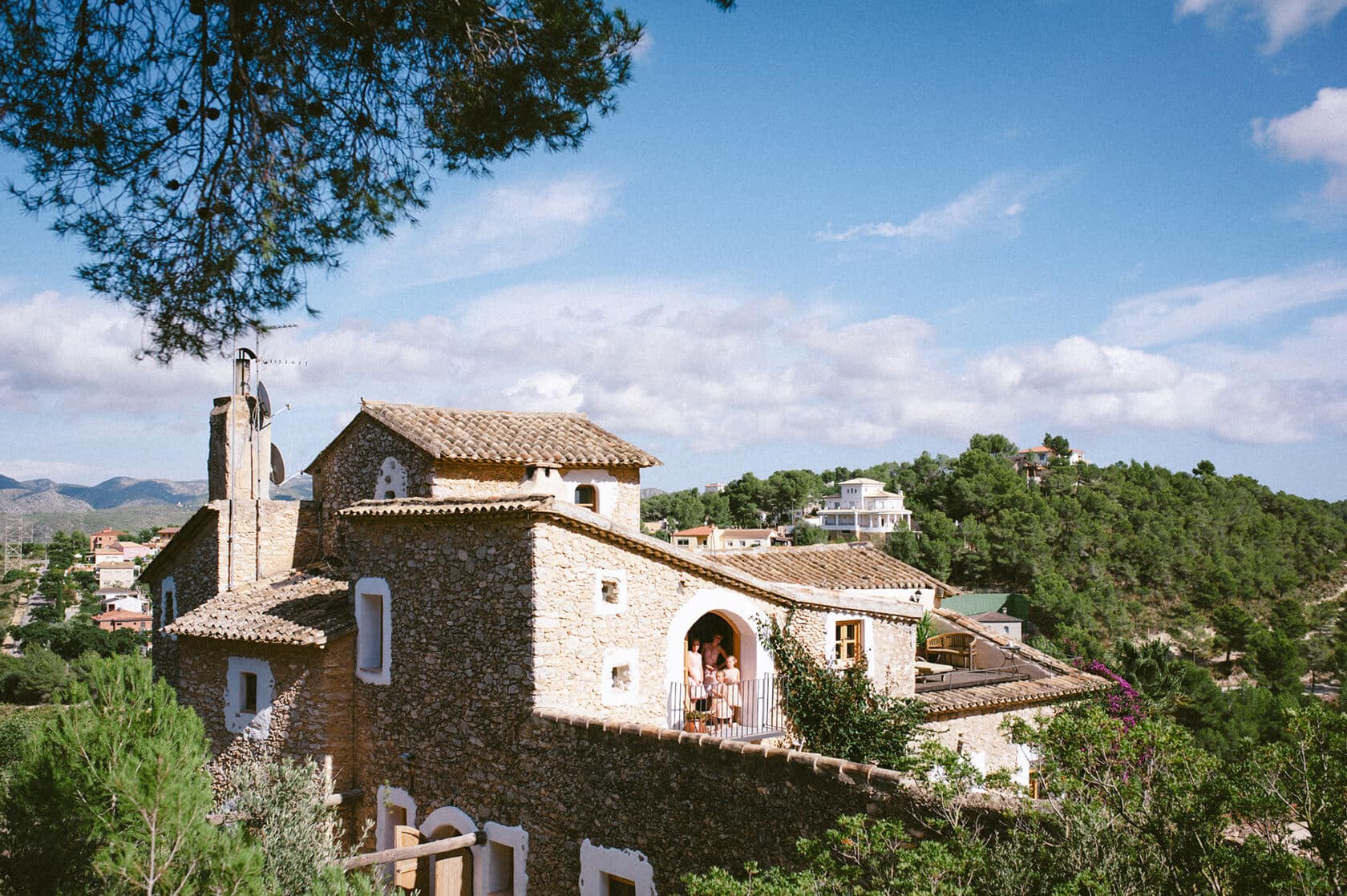 Stone wedding villa with tiled roof in Sitges, surrounded by greenery. - Barcelona Wedding Photographer