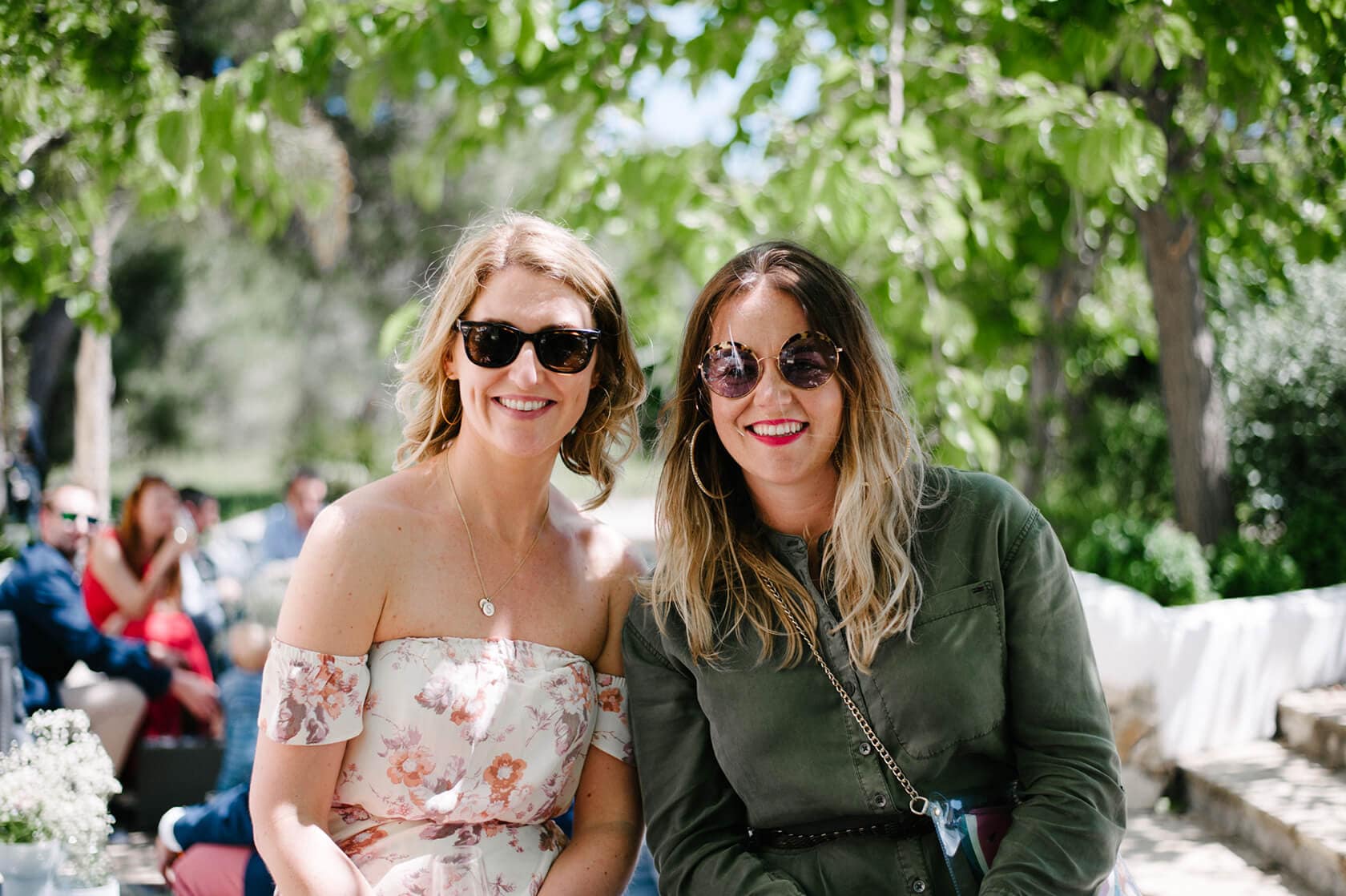 Two women smiling in sunglasses at Casanova Estate wedding venue. - Barcelona Wedding Photographer