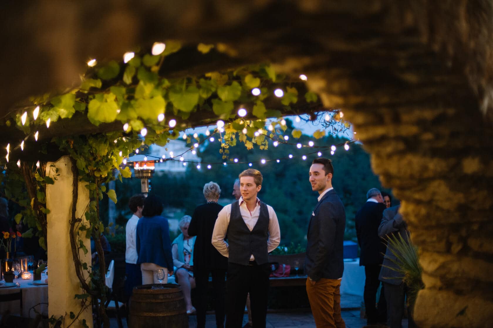 Men in suits at an outdoor wedding reception in Sitges - Barcelona Wedding Photographer