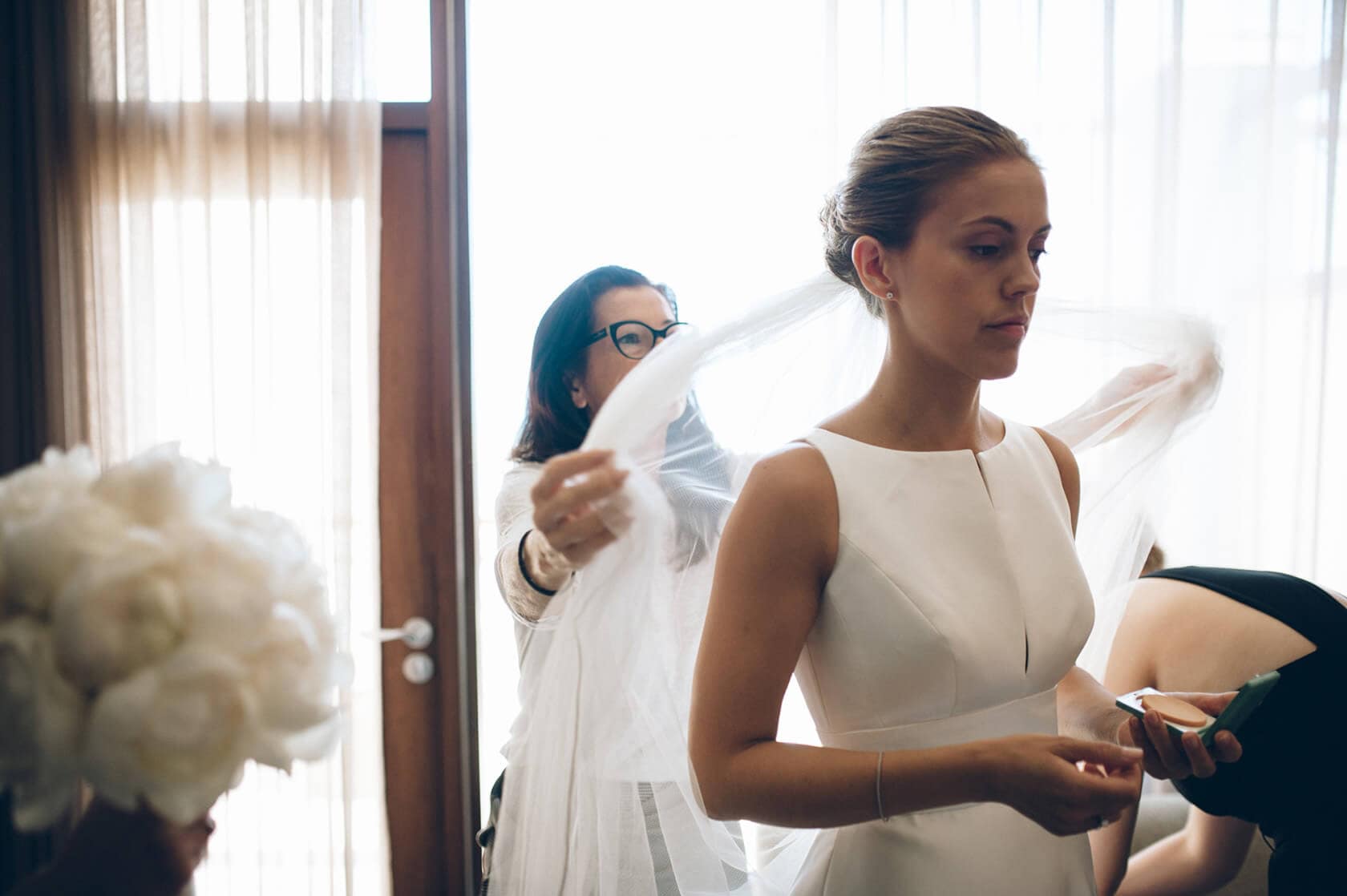 Bride getting ready for Hotel Miramar Barcelona wedding, veil being placed - Barcelona Wedding Photographer