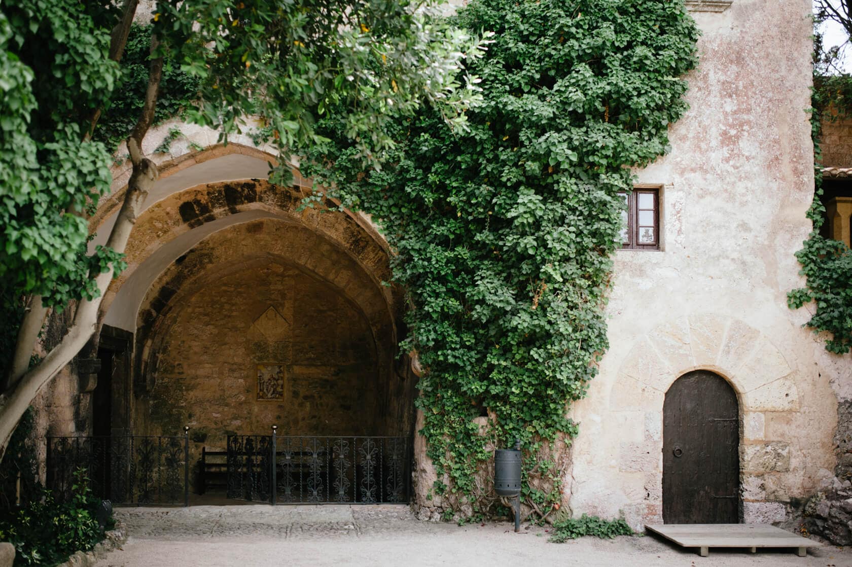 Castell de Tamarit wedding venue with ivy-covered wall and arched entrance - Barcelona Wedding Photographer