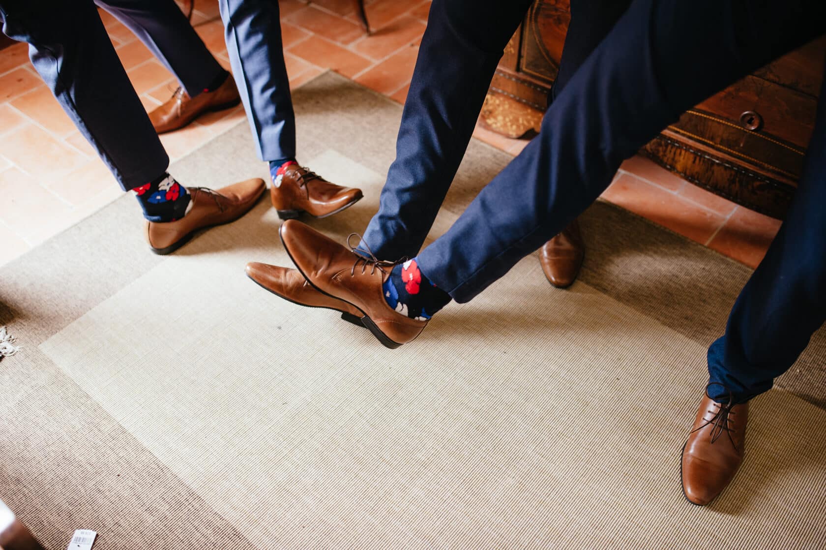 Groom and groomsmen in brown shoes and floral socks at a wedding. - Barcelona Wedding Photographer