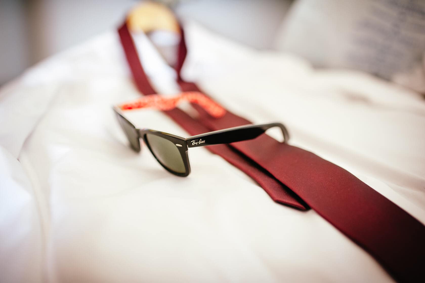 Ray-Ban sunglasses on a white shirt with a maroon tie, Sitges wedding - Barcelona Wedding Photographer