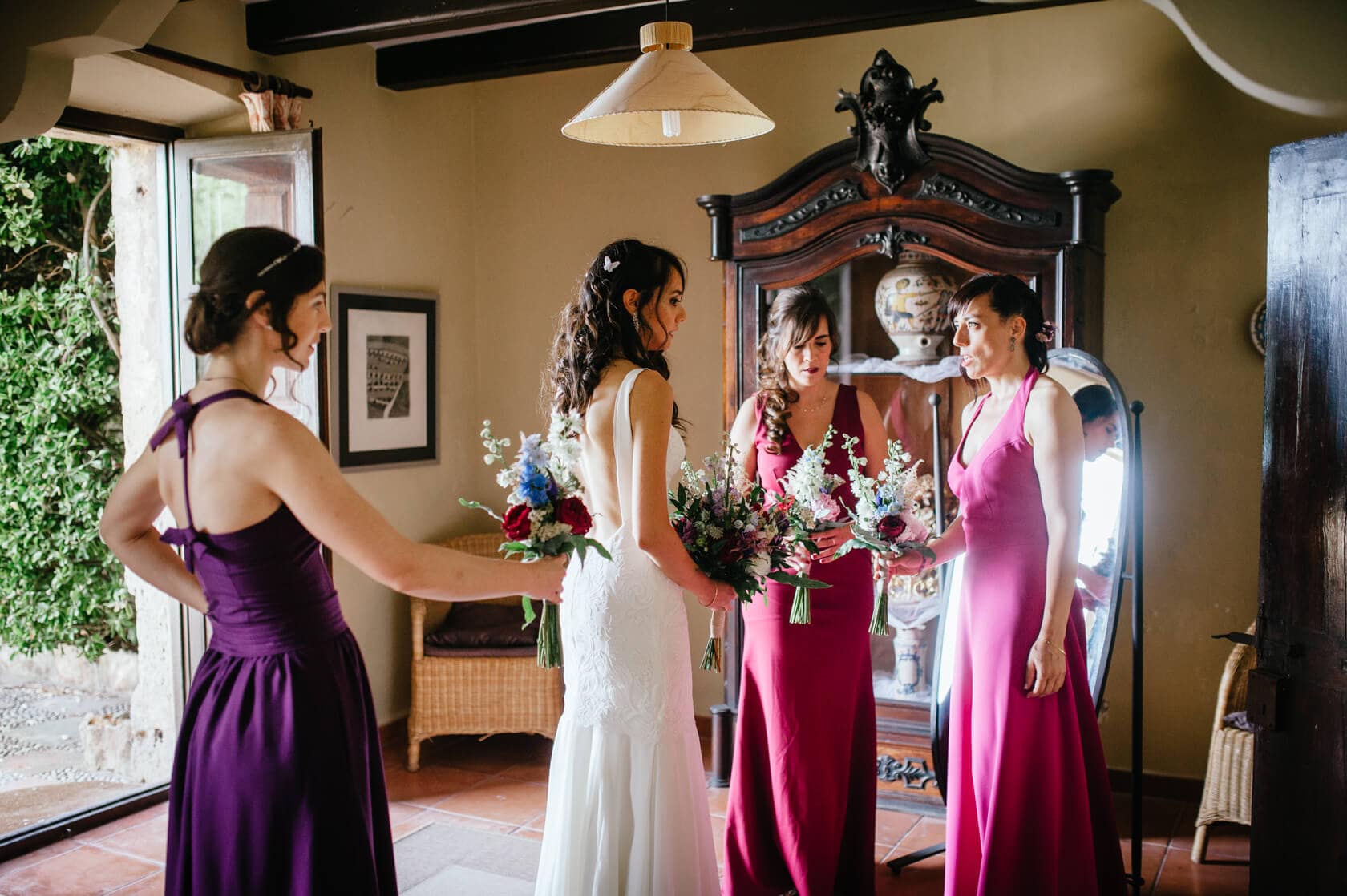 Bride and bridesmaids in purple and pink dresses at Castell de Tamarit wedding - Barcelona Wedding Photographer