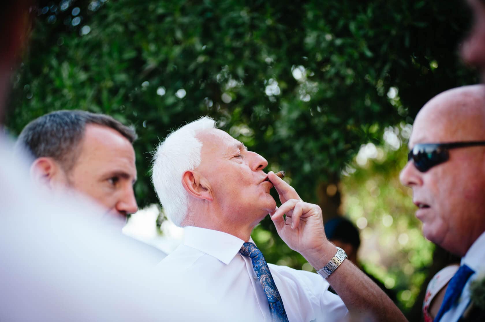 Groom smoking at Castell de Tamarit wedding, Sitges, Spain. - Barcelona Wedding Photographer