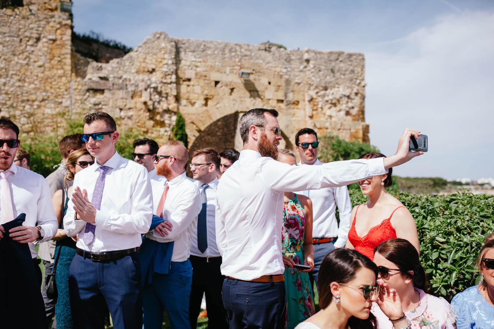 Wedding guests at Castell de Tamarit, Sitges, captured by Fotografia-Sitges. - Barcelona Wedding Photographer