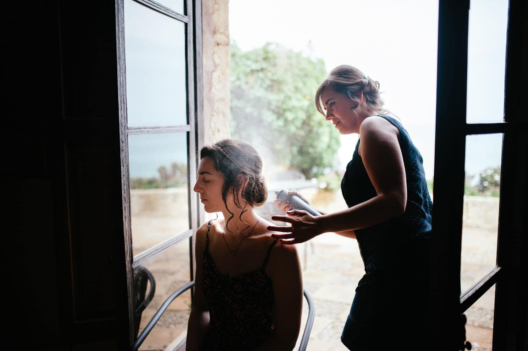 Bride getting hair sprayed before wedding at Castell de Tamarit, Sitges - Barcelona Wedding Photographer
