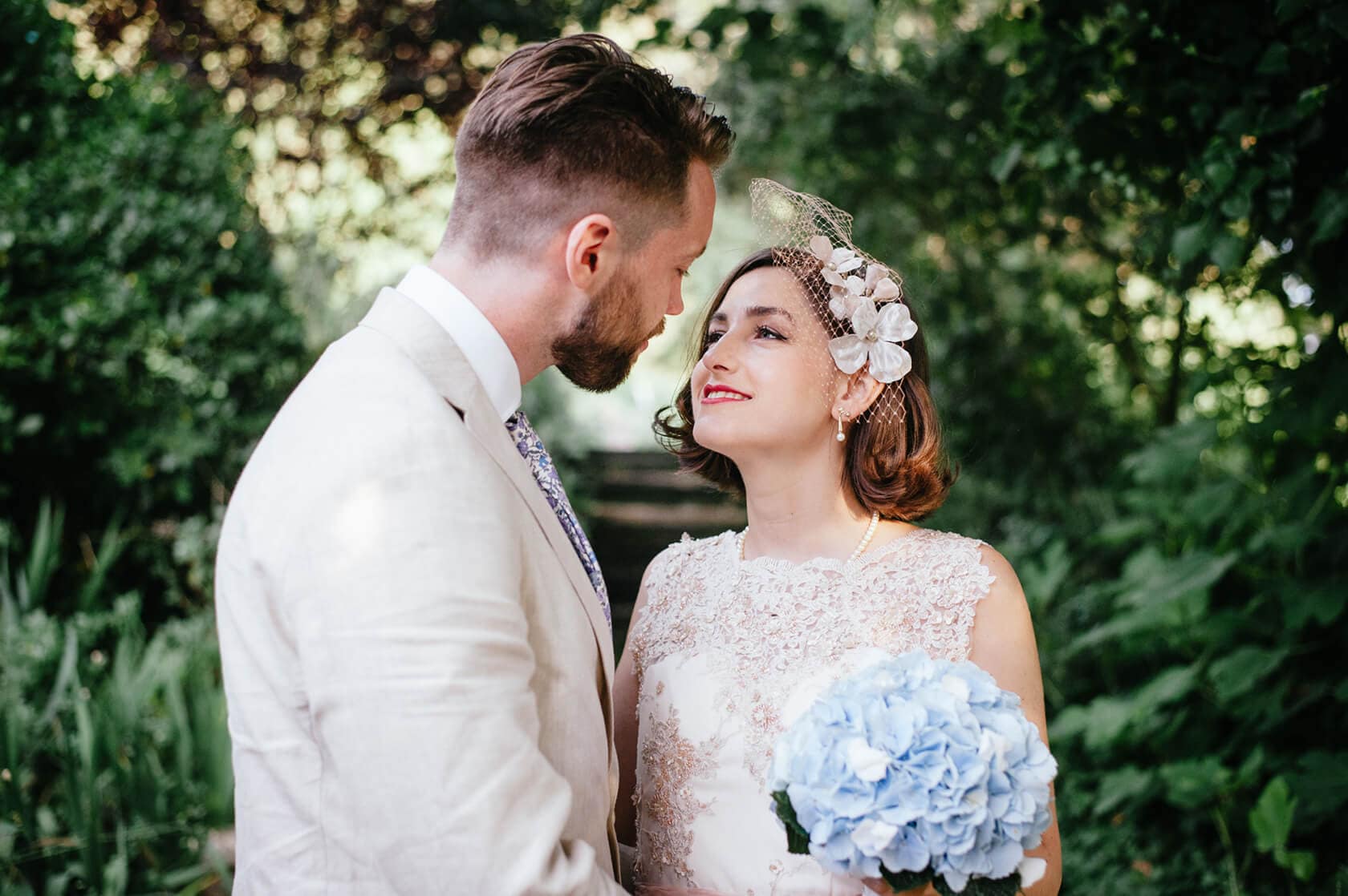 Bride and groom in vintage style wedding attire, looking at each other - Barcelona Wedding Photographer
