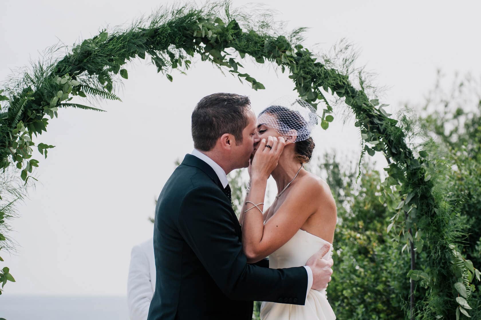 Hayley and Mark, a bride and groom, walk hand-in-hand at their wedding. - Barcelona Wedding Photographer